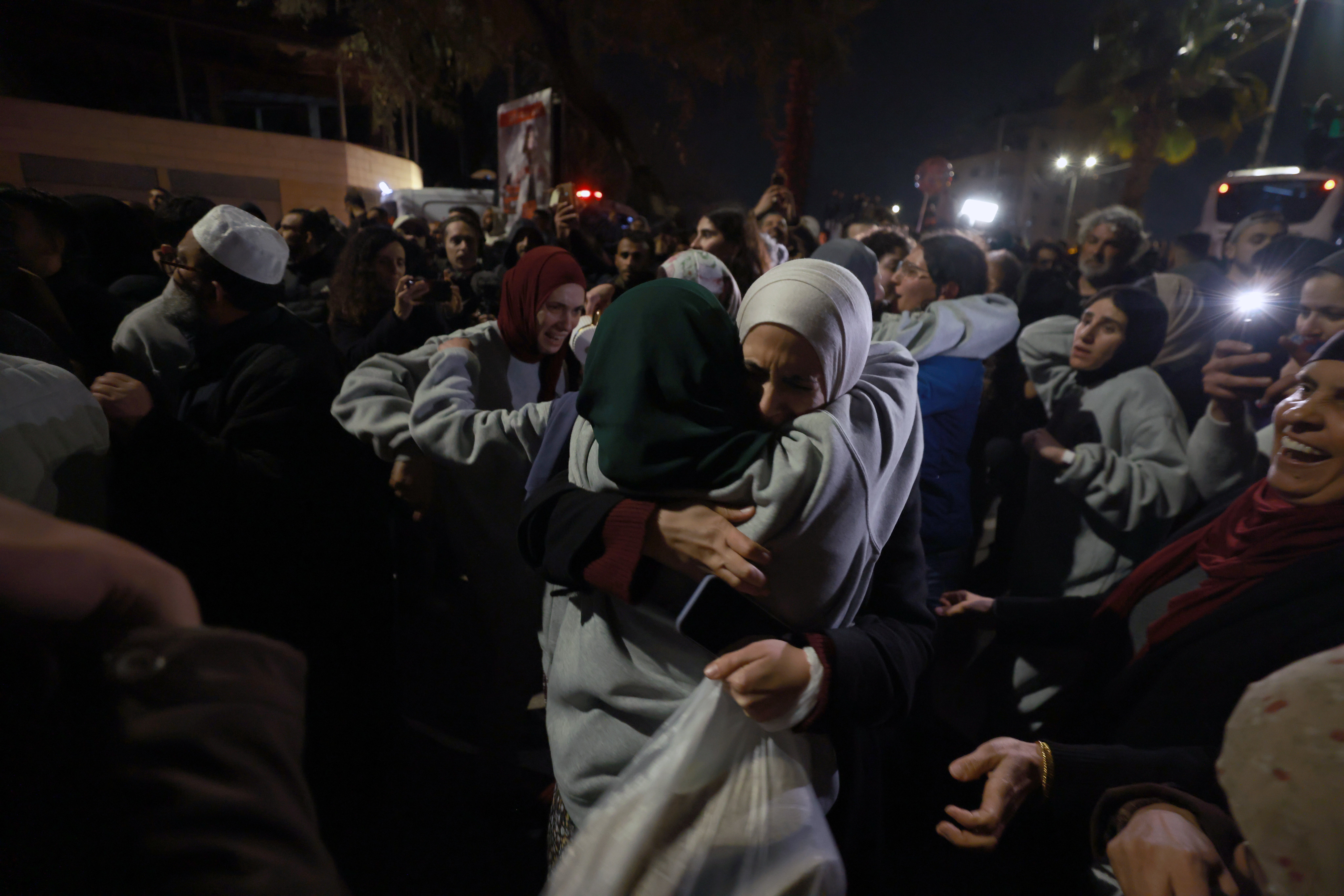 Released Palestinian prisoners from the Ofer Israeli military prison are greeted by relatives as they arrive in the West Bank city of Ramallah