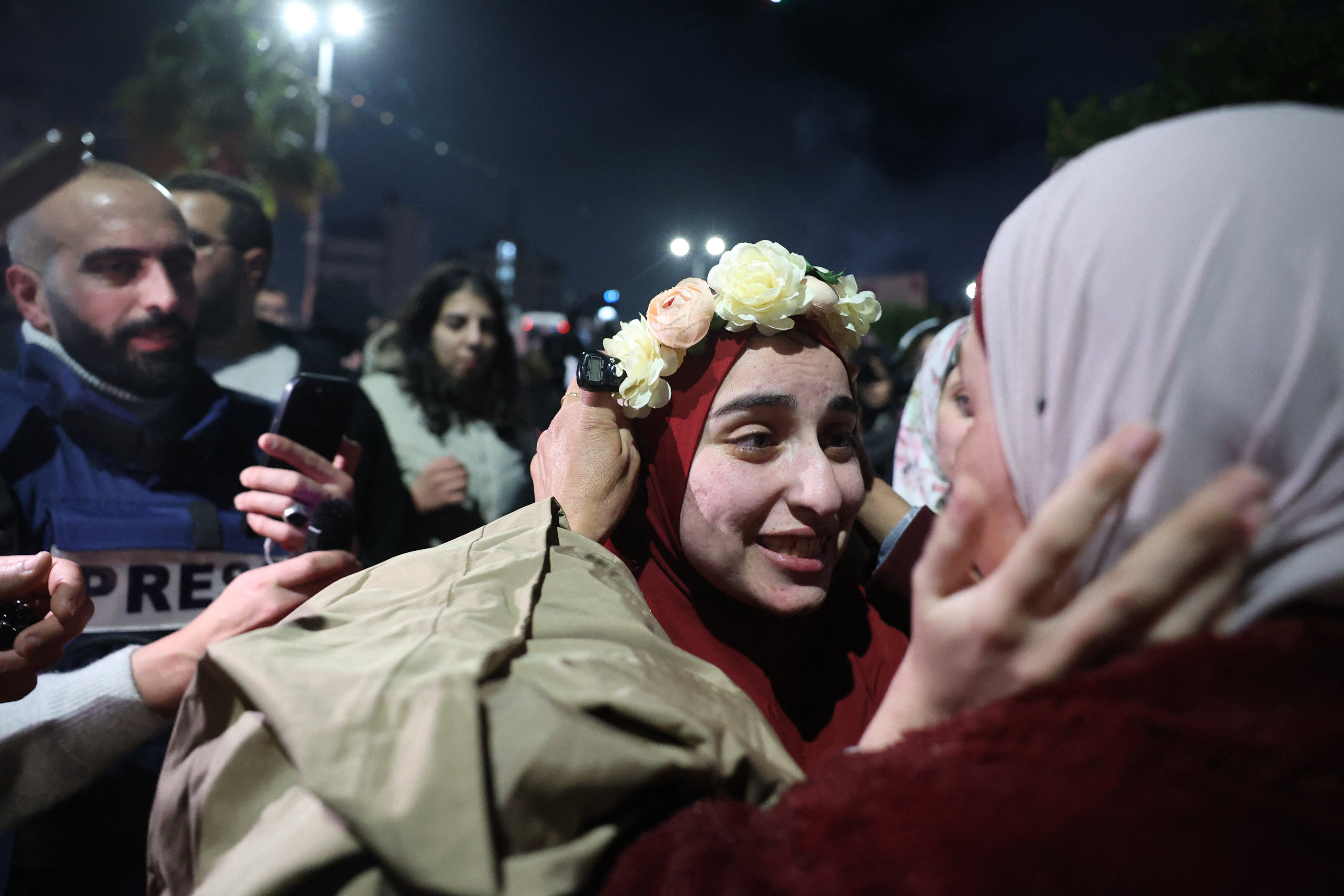 A Palestinian prisoner is welcomed by a relative upon the arrival of some 90 prisoners set free by Israel