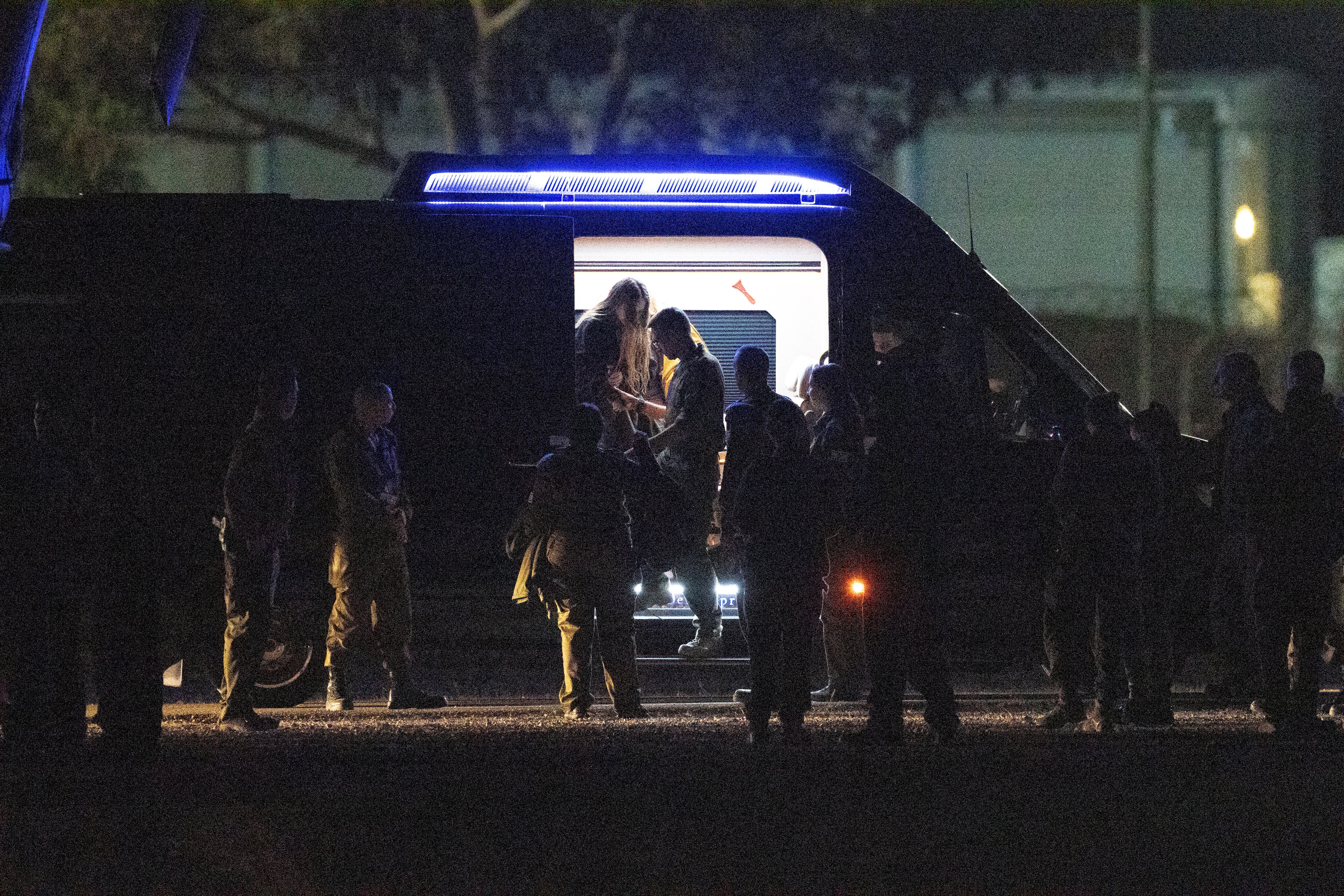 Israeli Doron Steinbrecher, who was kidnapped in Gaza by Hamas on Oct. 7, steps out of a van before boarding a helicopter after being released from Gaza