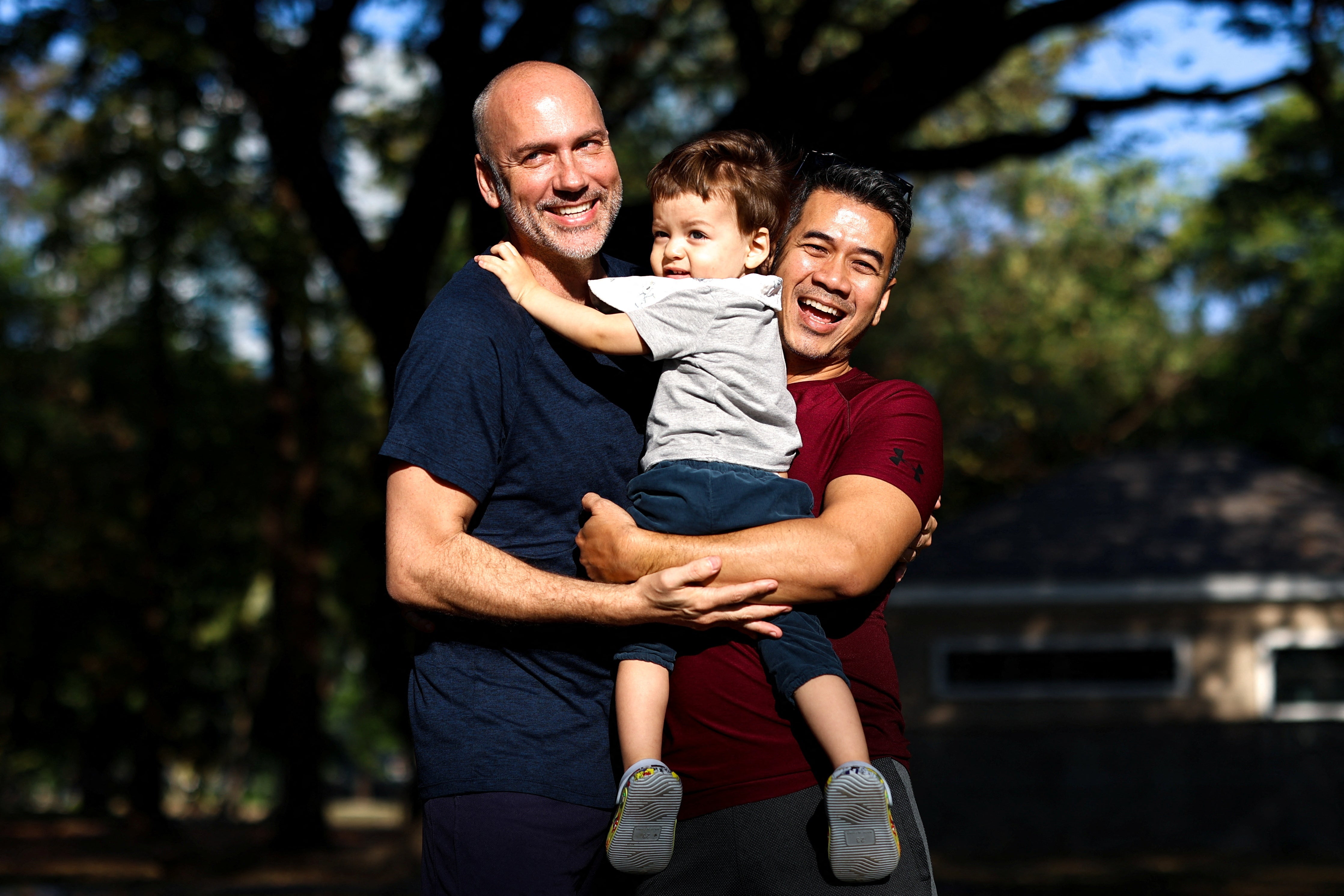 Couple, Jacob Holder, 45, and Surapong "Keng" Koonpaew, 48, hold their son, Elijah Bprin Holder Koonpaew