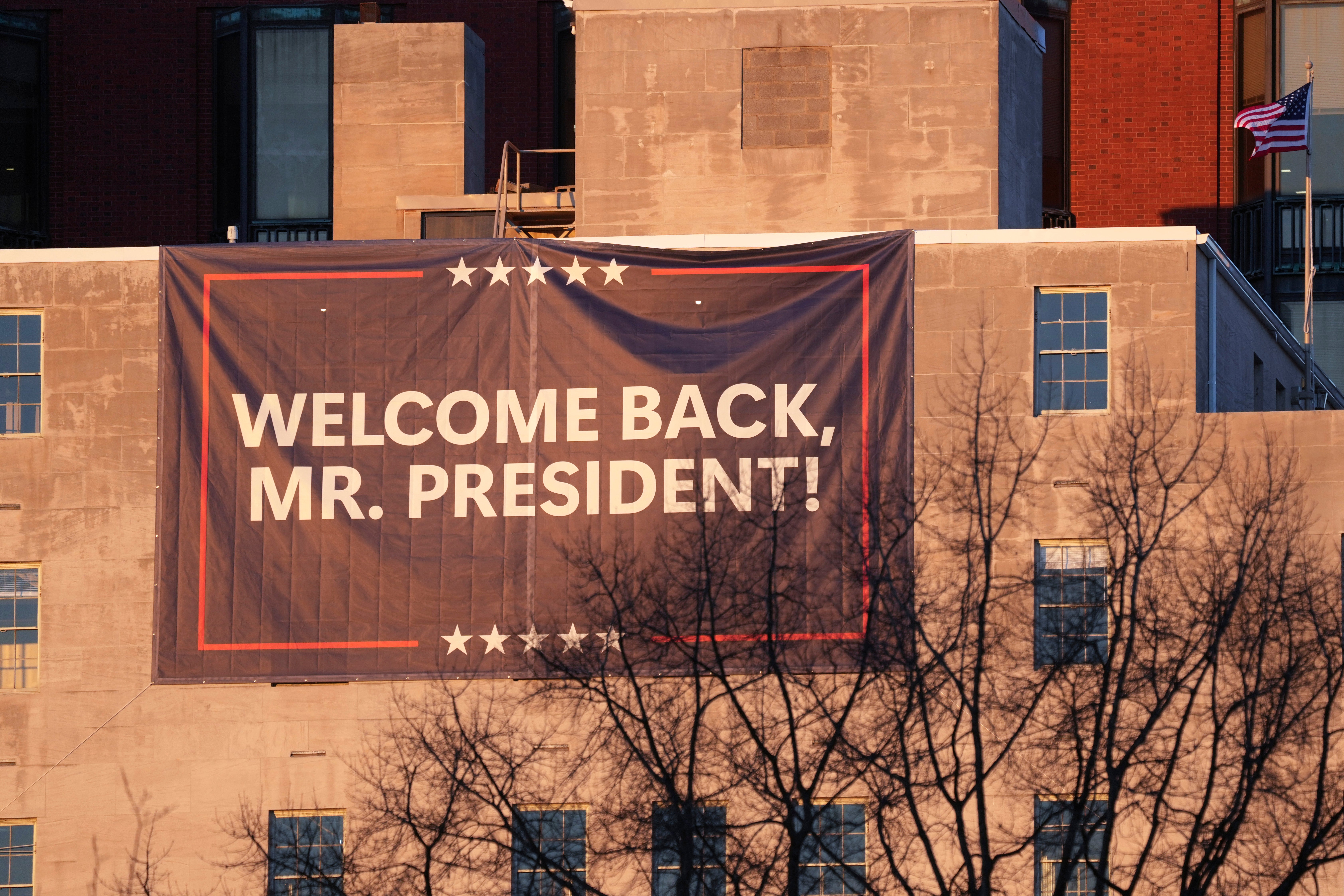 A sign near St John’s Episcopal Church across from the White House in Washington welcomes back Donald Trump