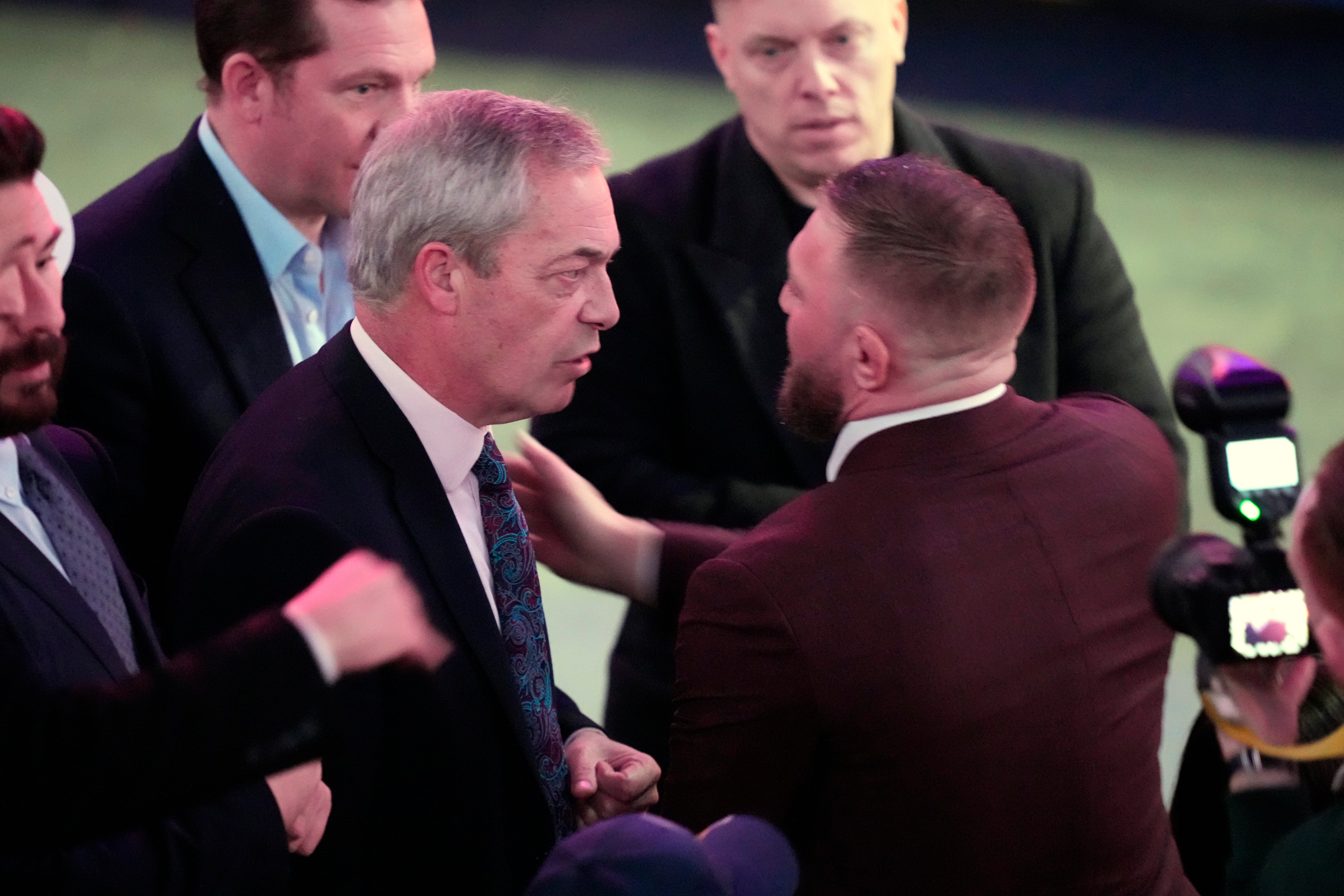 Reform UK leader Nigel Farage, left, speaks with MMA fighter Conor McGregor before President-elect Donald Trump arrives at a rally