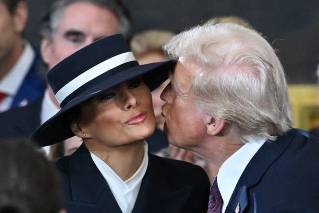 <p>Donald Trump greets his wife Melania Trump as he arrives for inauguration ceremonies in the Rotunda of the US Capitol. Her huge hat kept him from landing the kiss at first.  </p>