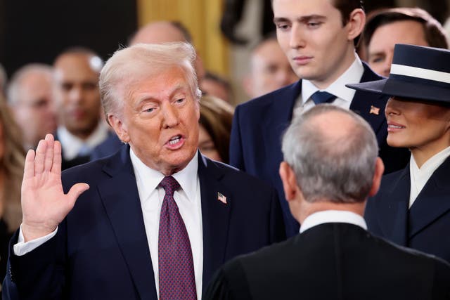 <p>President-elect Donald Trump, from left, takes the oath of office as son Barron Trump and wife Melania Trump watch during the 60th Presidential Inauguration in the Rotunda of the U.S. Capitol in Washington, Monday, Jan. 20, 2025. (Kevin Lamarque/Pool Photo via AP)</p>