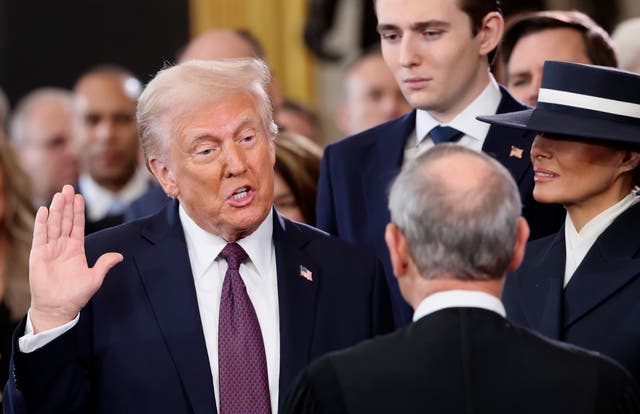 <p>President-elect Donald Trump, from left, takes the oath of office as son Barron Trump and wife Melania Trump watch during the 60th Presidential Inauguration in the Rotunda of the U.S. Capitol in Washington, Monday, Jan. 20, 2025 </p>