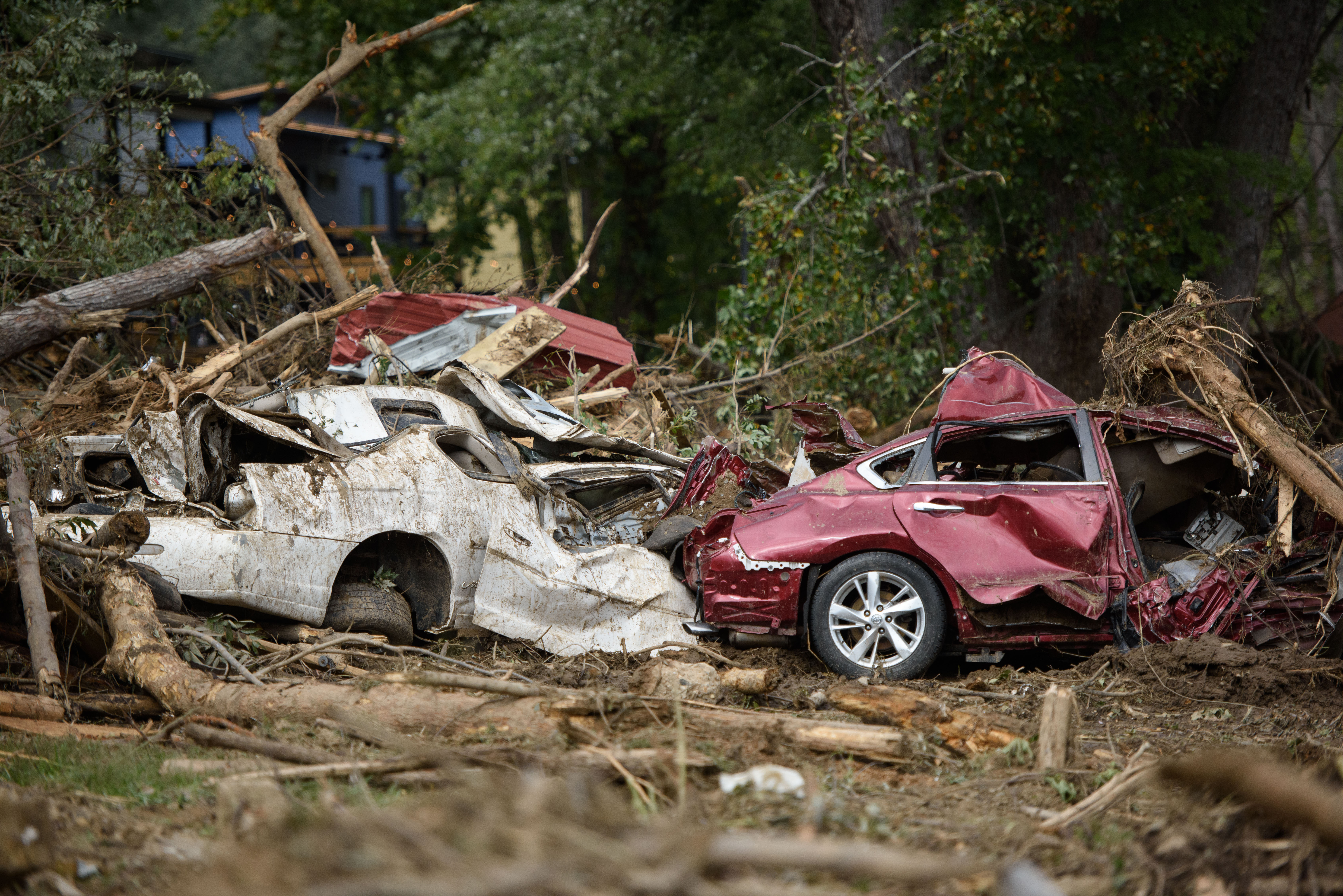 Crushed vehicles are uncovered after days in debris in the aftermath of Hurricane Helene last September in Old Fort, North Carolina. The storm dropped 40 trillion gallons of water on the Southeast