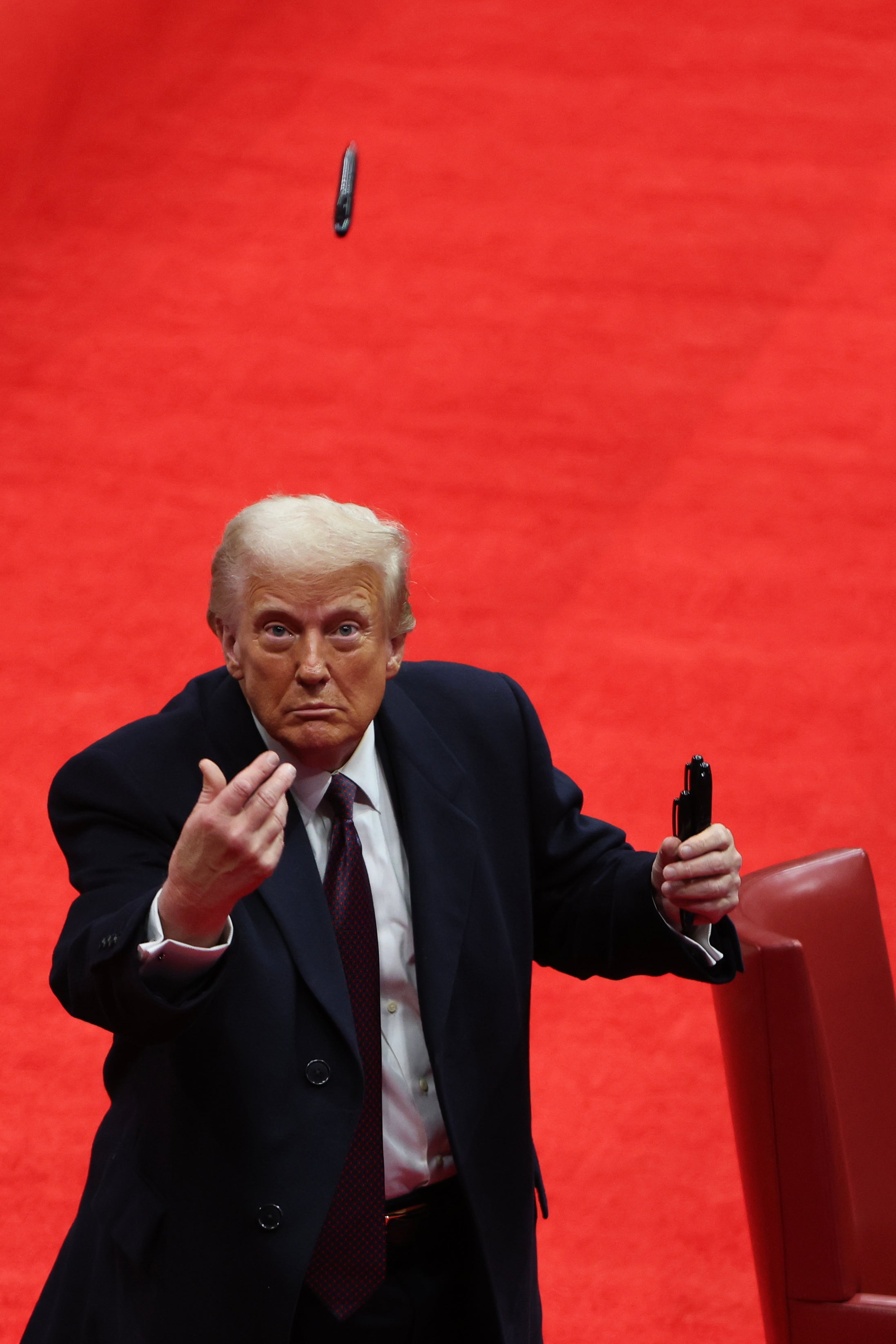 Trump throws pens to fans after signing executive orders at the Capitol One Arena