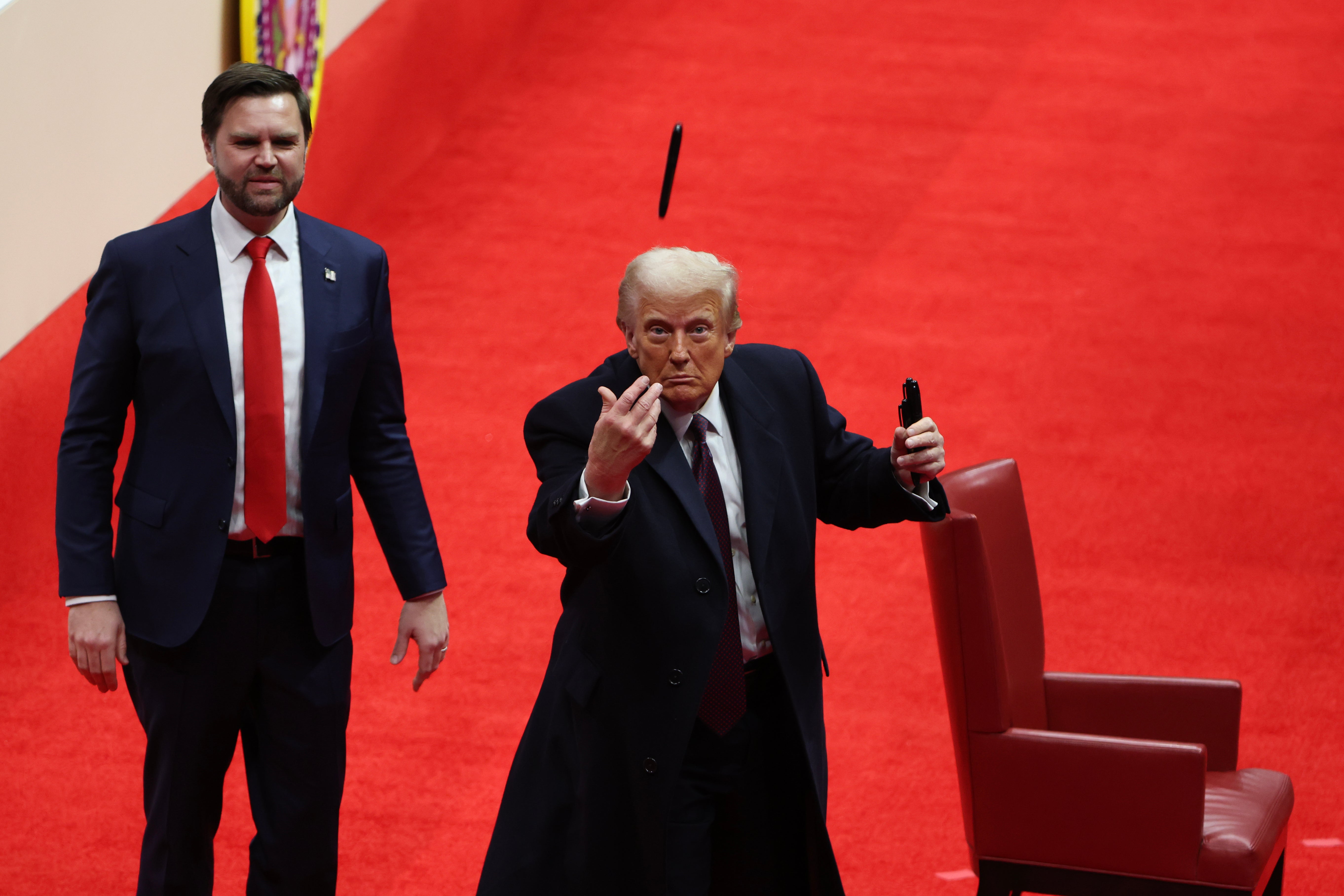 Vice President J.D. Vance watches as President Donald Trump throws a pen after signing executive orders during an indoor inauguration parade at Capital One Arena on January 20, 2025 in Washington, DC. Donald Trump takes office for his second term as the 47th president of the United States. (Photo by Justin Sullivan/Getty Images)