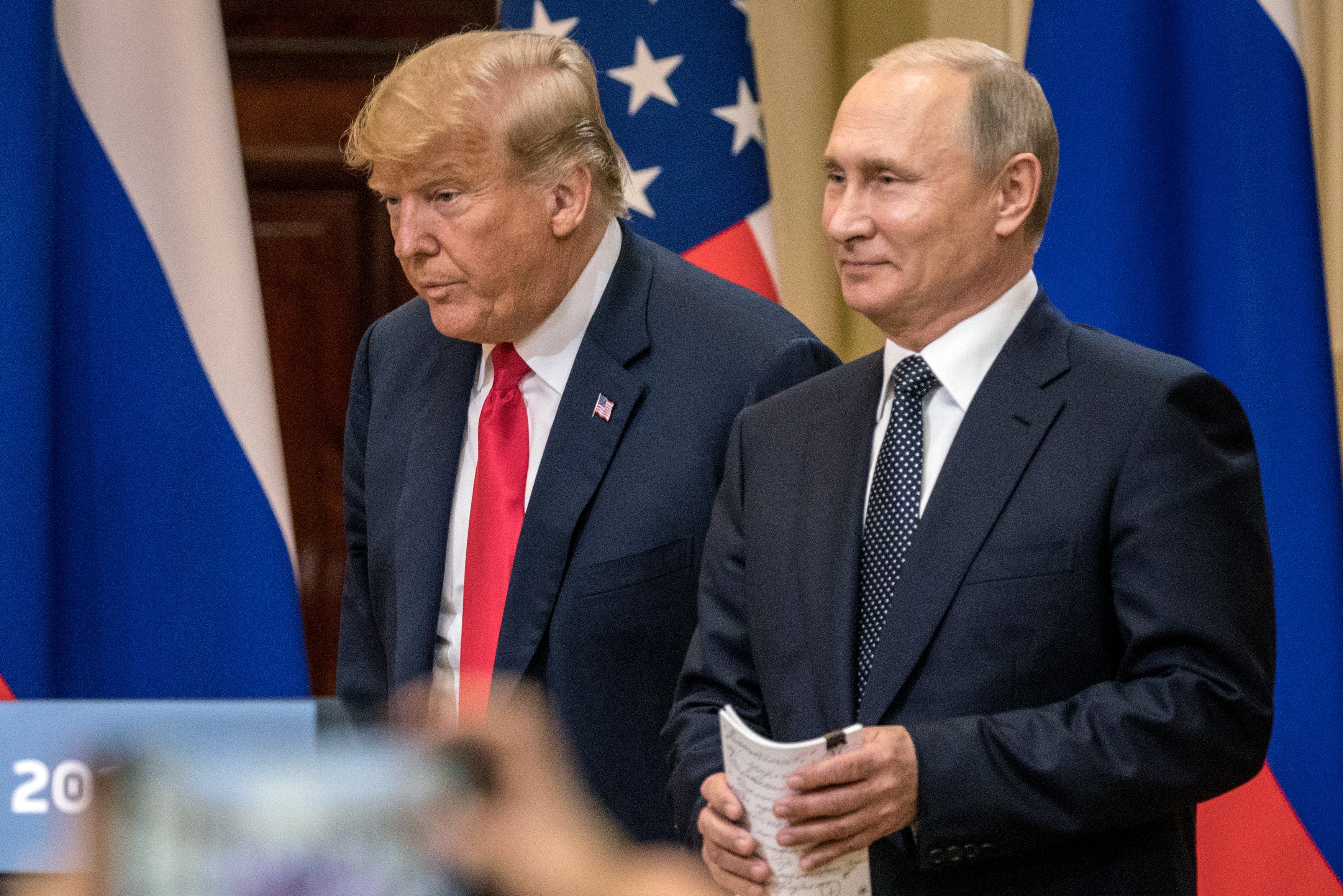 Donald Trump and Vladimir Putin arrive to waiting media during a joint press conference in Helsinki