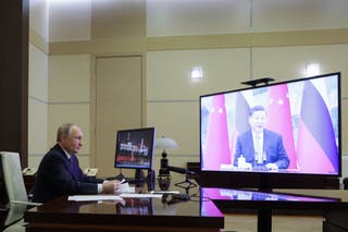 Russian President Vladimir Putin speaks with Chinese President Xi Jinping via videoconference at Novo-Ogaryovo state residence