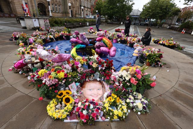 A photo of Elsie Dot Stancombe among the flowers and tributes outside the Atkinson Art Centre, Southport (Paul Currie/PA)