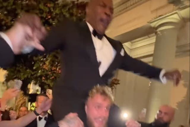 <p>Jake Paul hoists former boxing opponent Mike Tyson onto his shoulders</p>