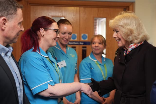 Queen Camilla meets staff members during her visit to the hospice (Jacob King/PA)