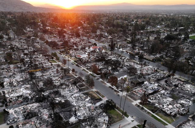 <p>The sun rises above homes that burned in the Eaton fire in Altadena, California</p>