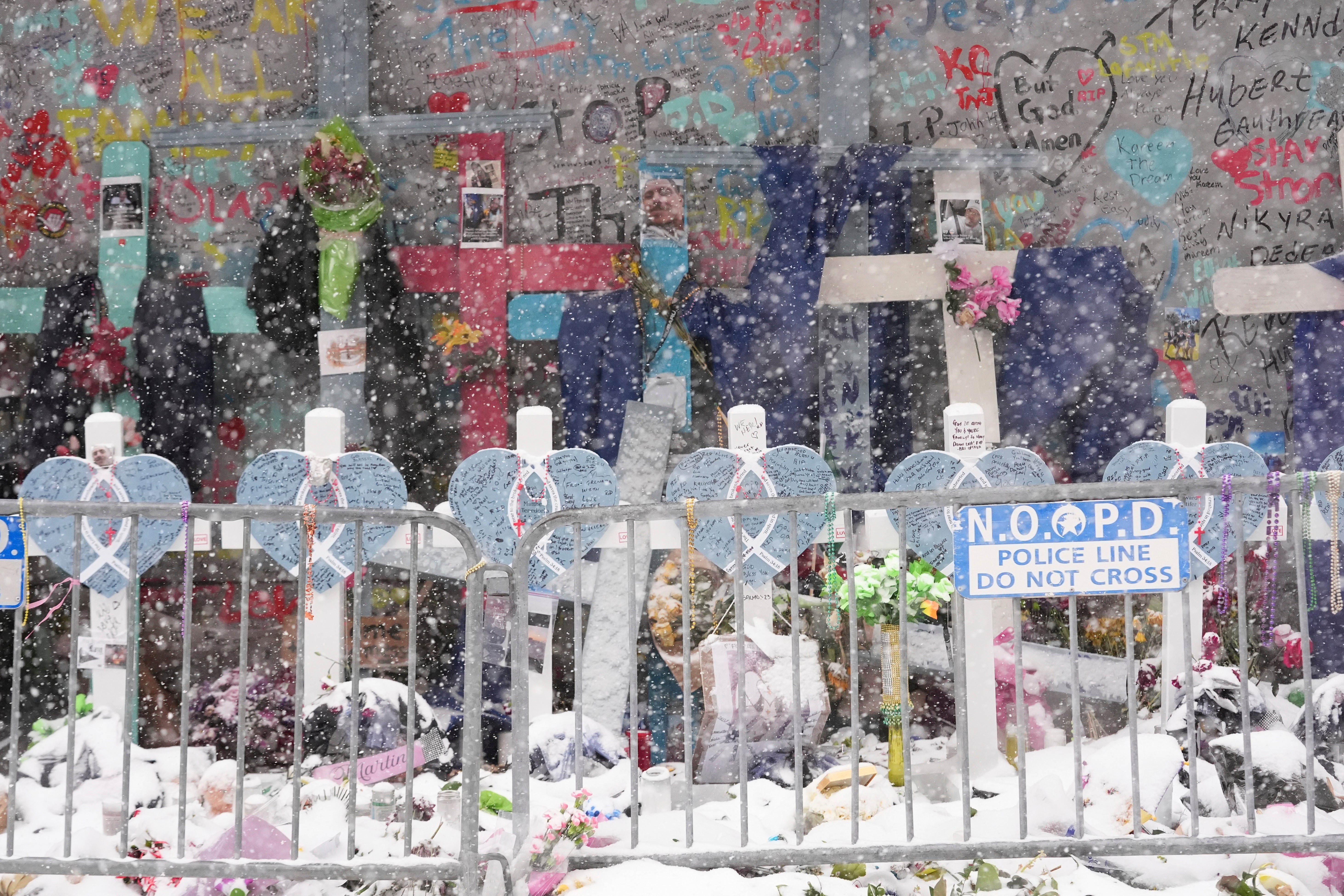 Snow falls as the memorial for the victims of a deadly truck attack on New Year's Day is seen in New Orleans, Louisiana, on Tuesday. The area around the city had already seen several inches of snow