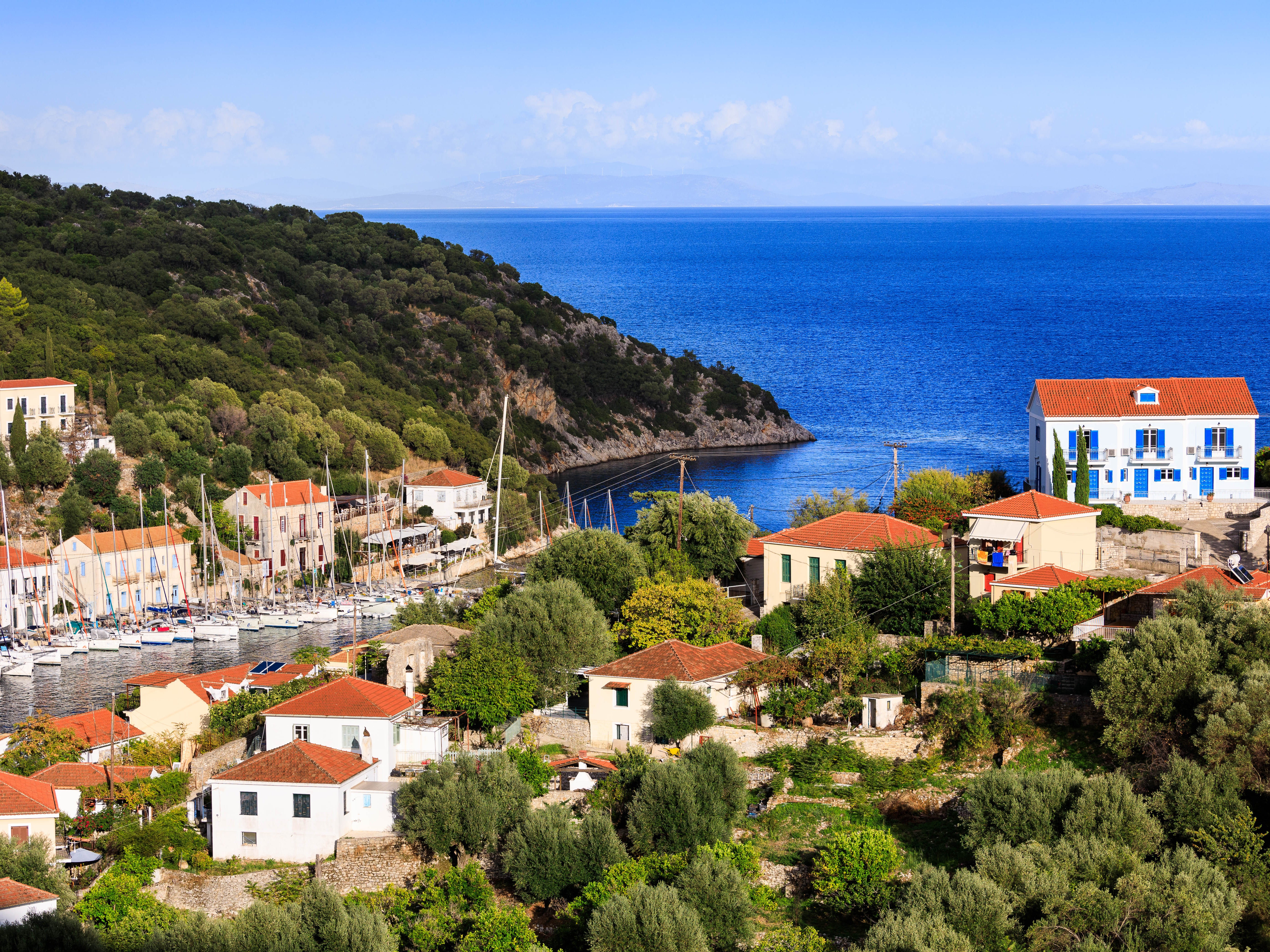 A view of the blue-shuttered apartment overlooking the bay of Kioni