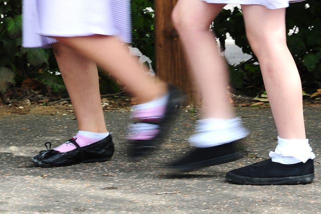 Girls walking to school (Ian West/PA)