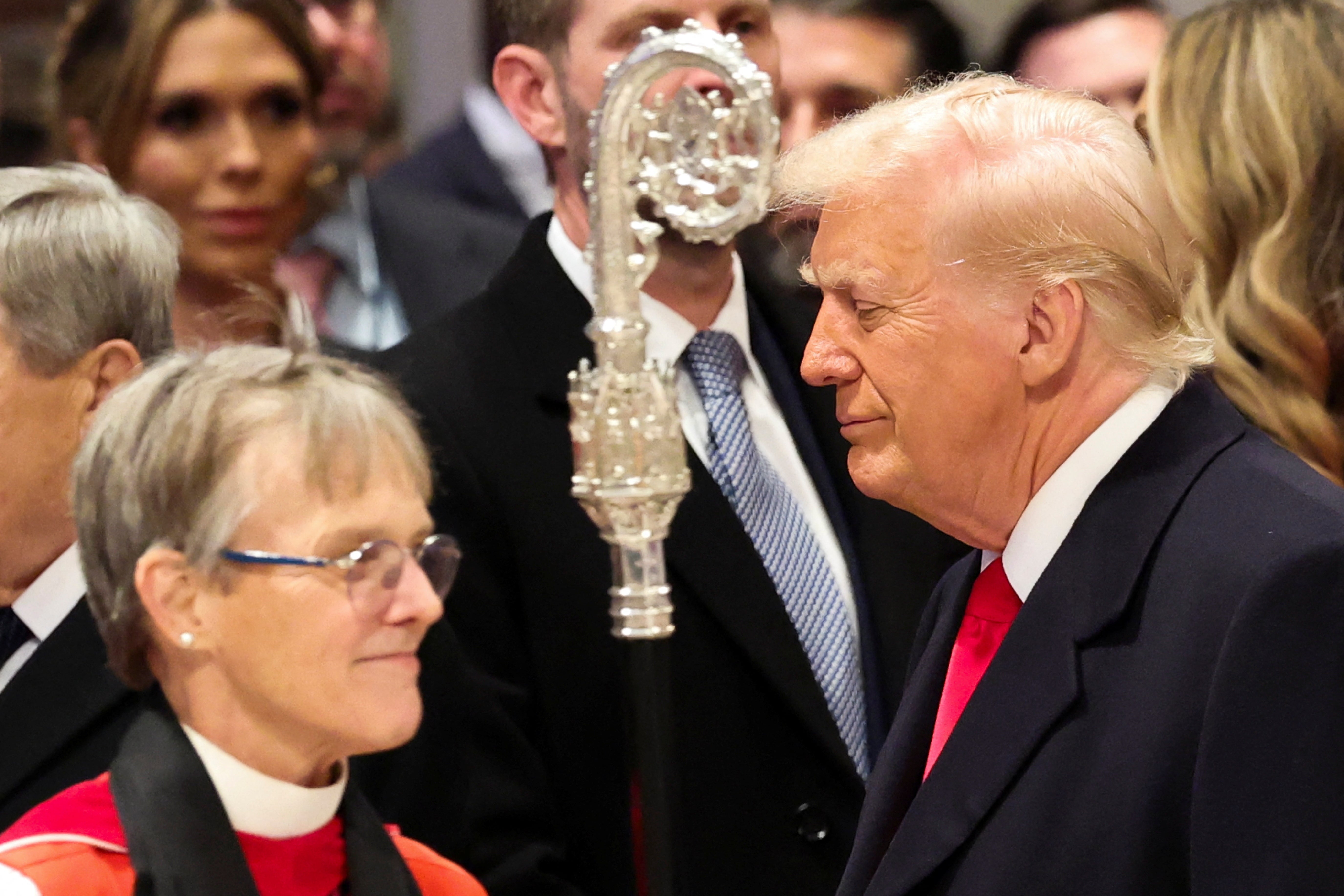 President Donald Trump stands near Reverend Mariann Edgar Budde as he attends the National Day of Prayer Service at the Washington National Cathedral.