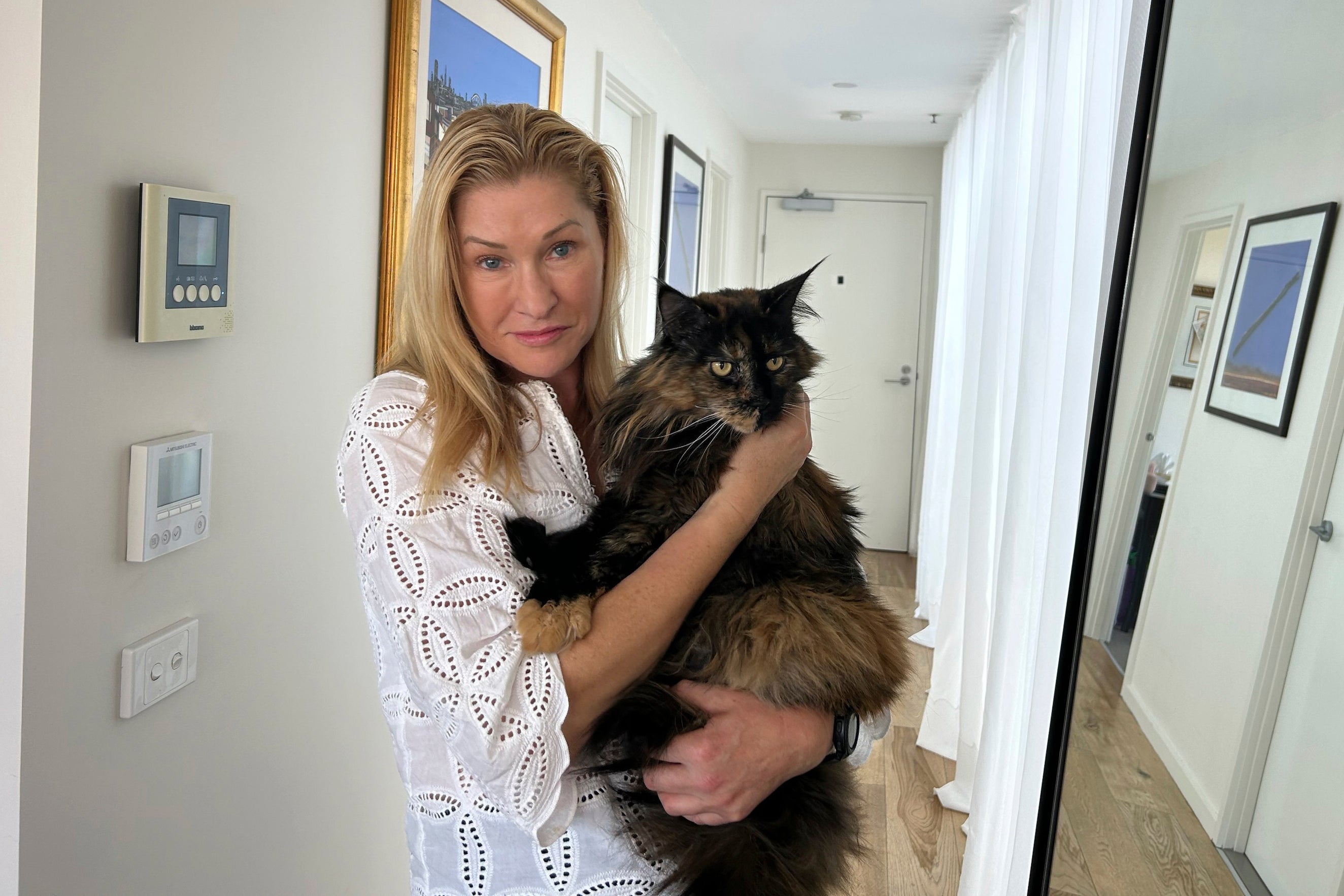 Margo Neas holds her cat Mittens at her home in Melbourne