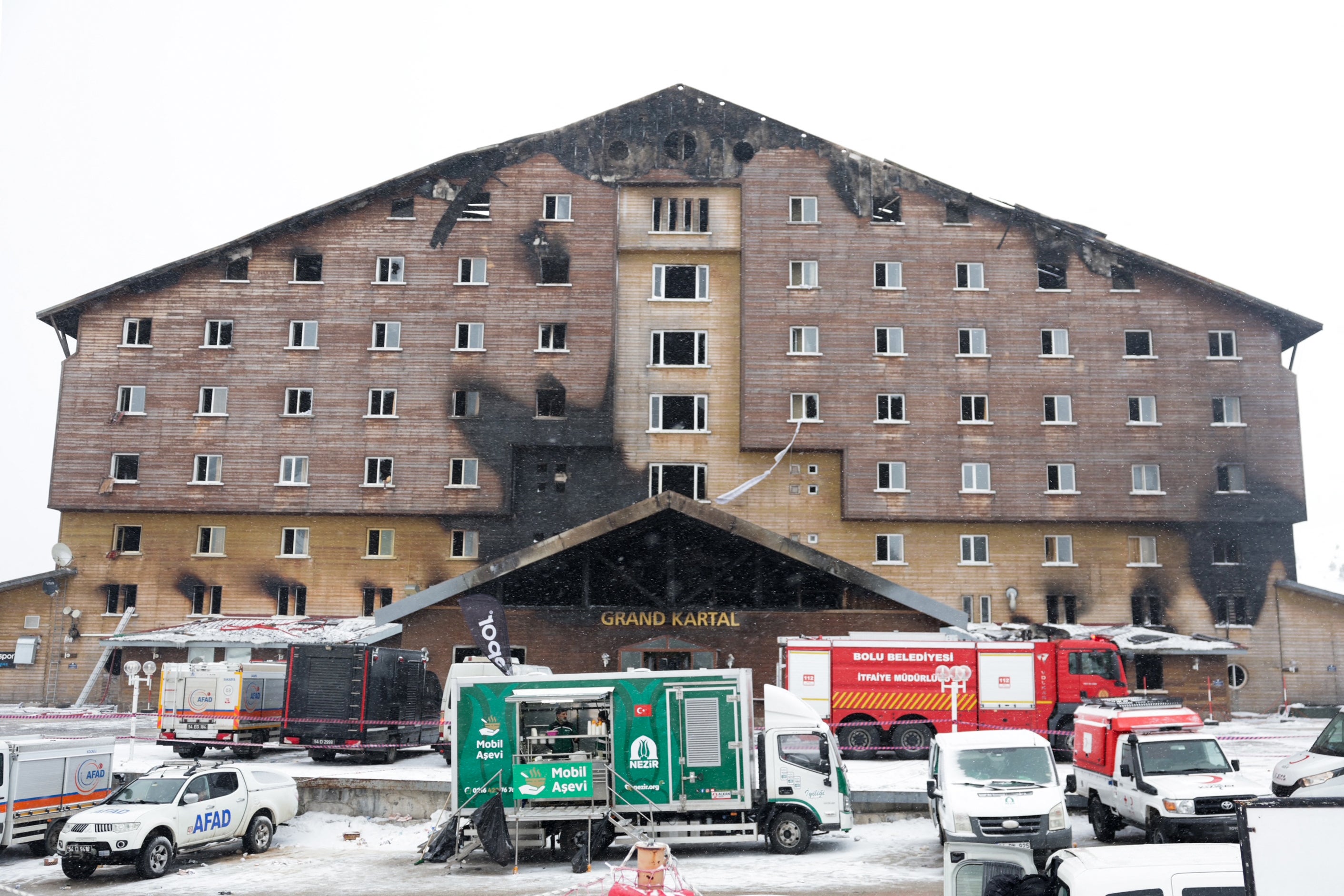 Firefighters and emergency services work in the aftermath of the fire