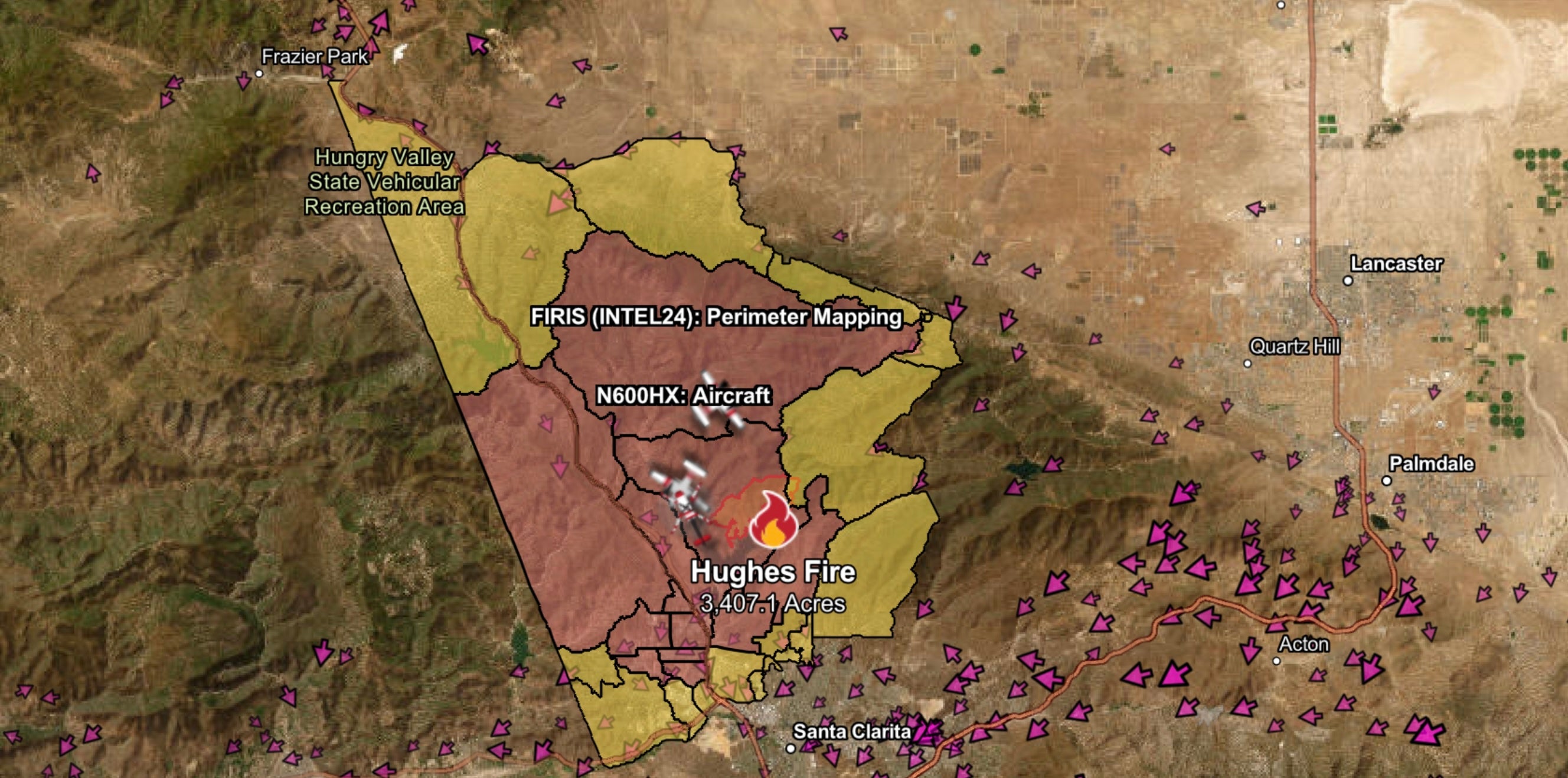 A map shows the Hughes Fire and affected communities near Santa Clarita, California. The wildfire has rapidly grown amid windy and dry conditions