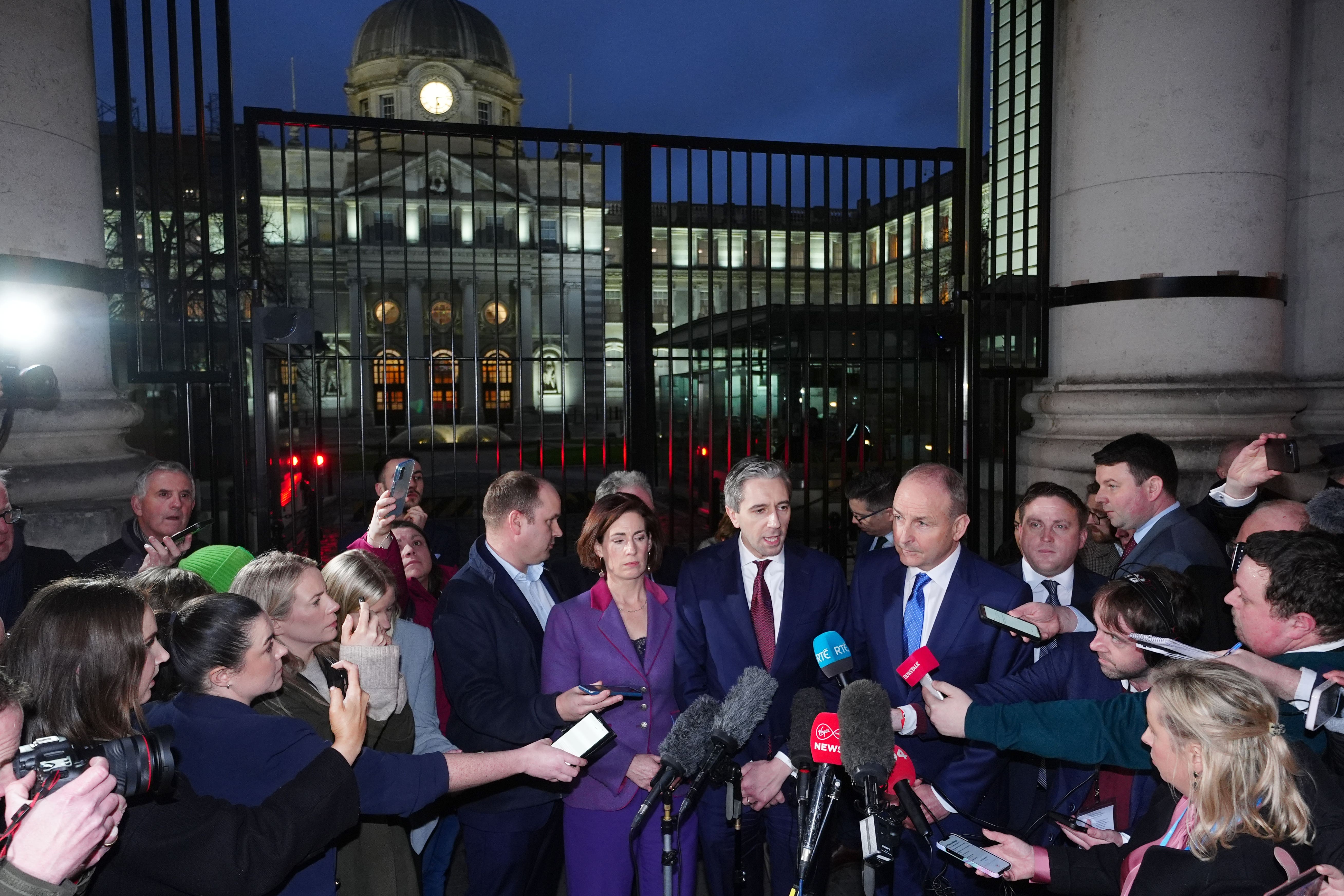(left to right) Government chief whip Hildegarde Naughton TD, Fine Gael leader Simon Harris TD, and Fianna Fail leader Micheal Martin address the media outside Government Buildings, Dublin, after the Dail was adjourned amid chaotic scenes on Wednesday