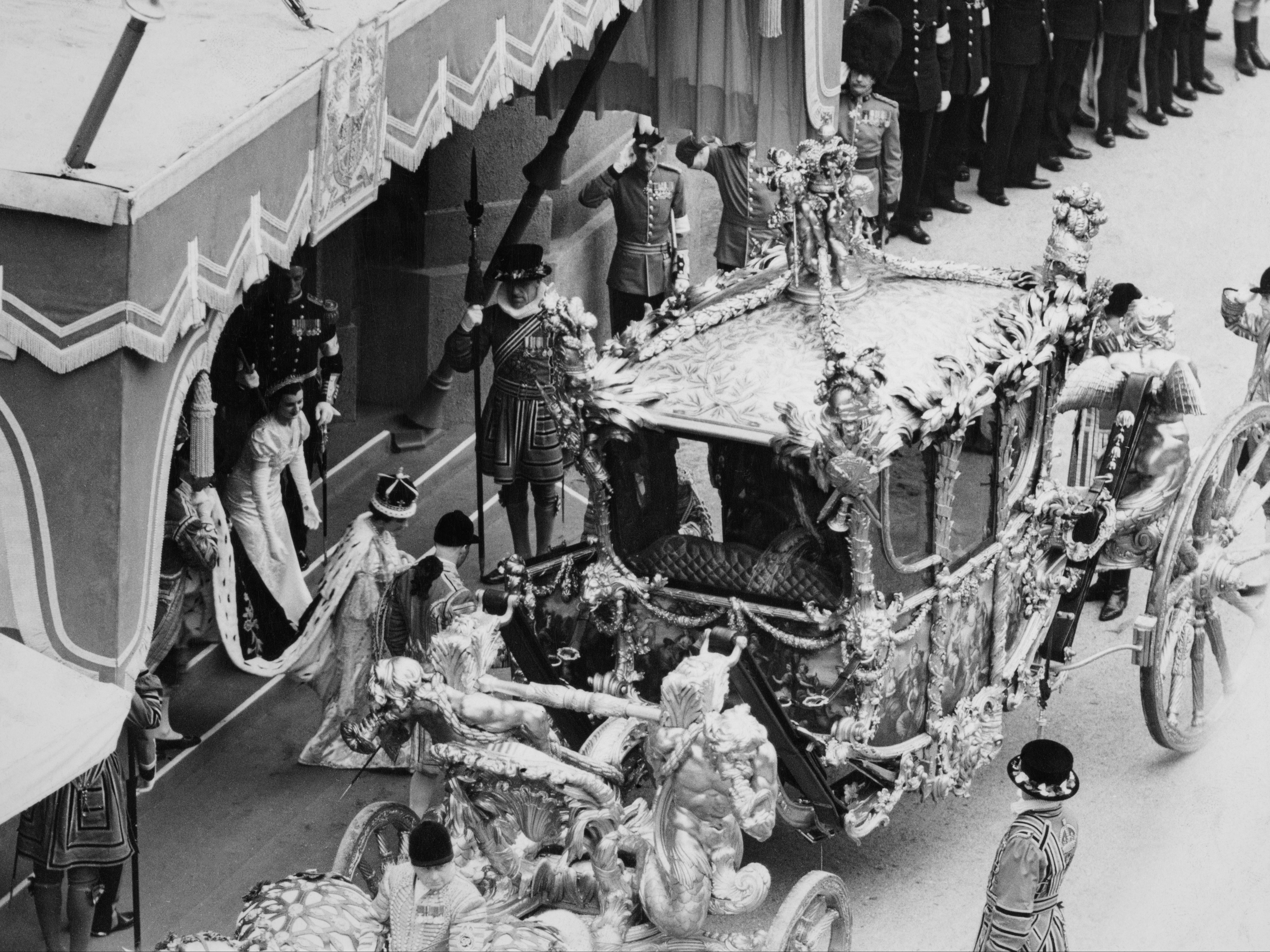 File. Queen Elizabeth II approaches the Gold State Coach following the coronation ceremony at Westminster Abbey in Westminster, London, England, 12th May 1937. The crown worn by Queen Elizabeth, the only crown for a British king or queen to be made of platinum, is decorated with approximately 2,800 diamonds, notably the Koh-i-Noor diamond in the middle of the front cross