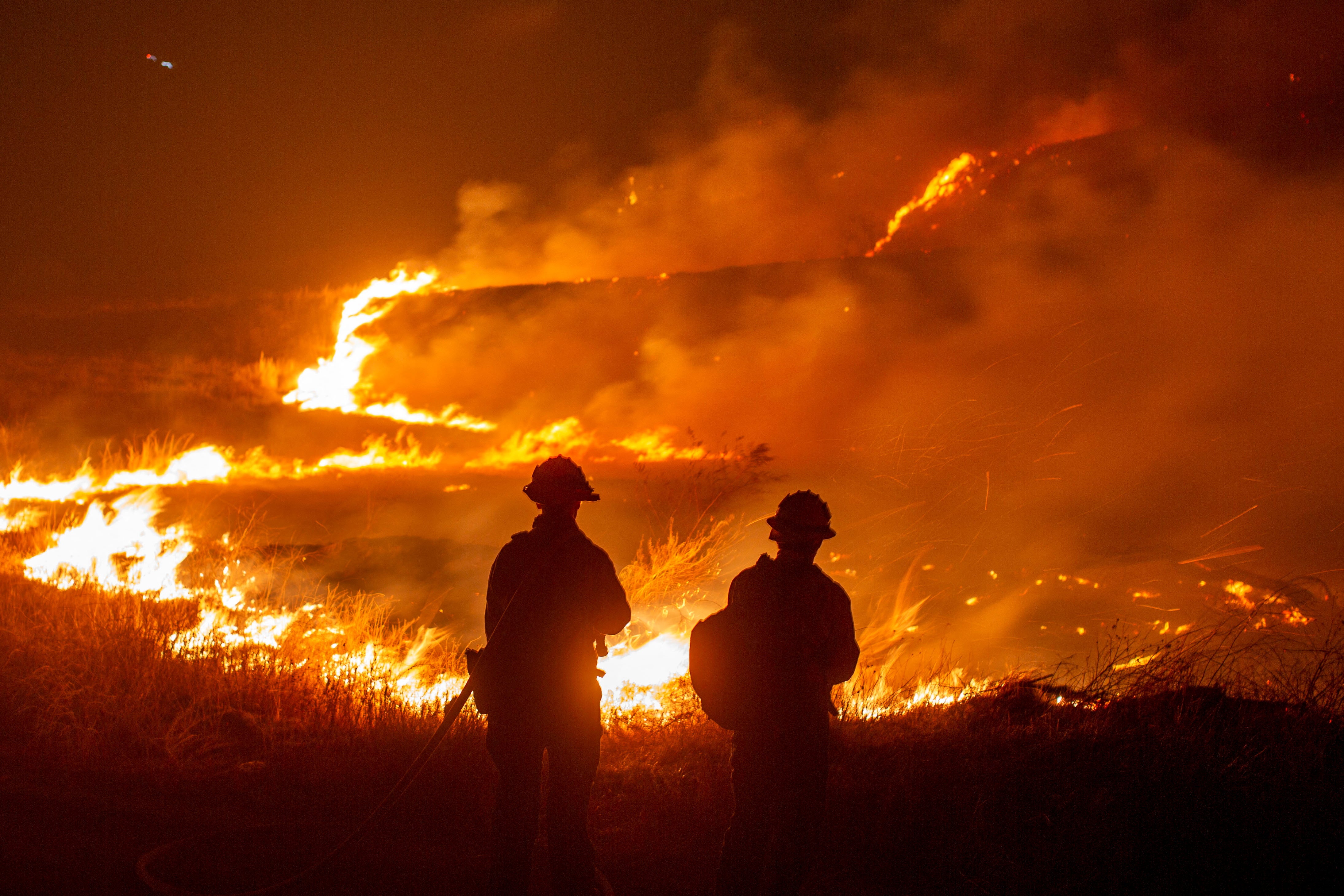 Firefighters and aircraft battle the Hughes Fire near Santa Clarita