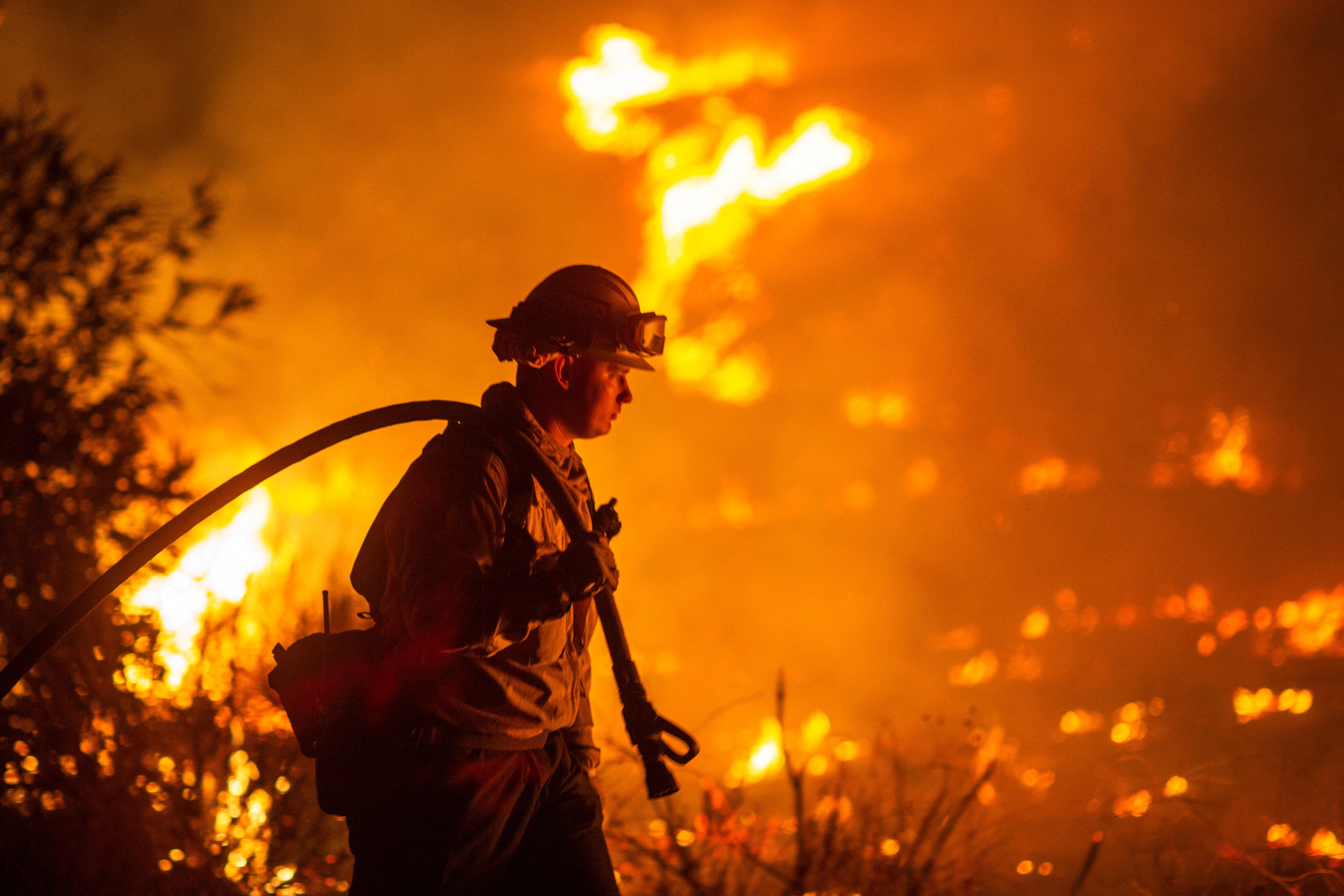 Firefighters battle the Hughes Fire near Castaic Lake north of Santa Clarita.