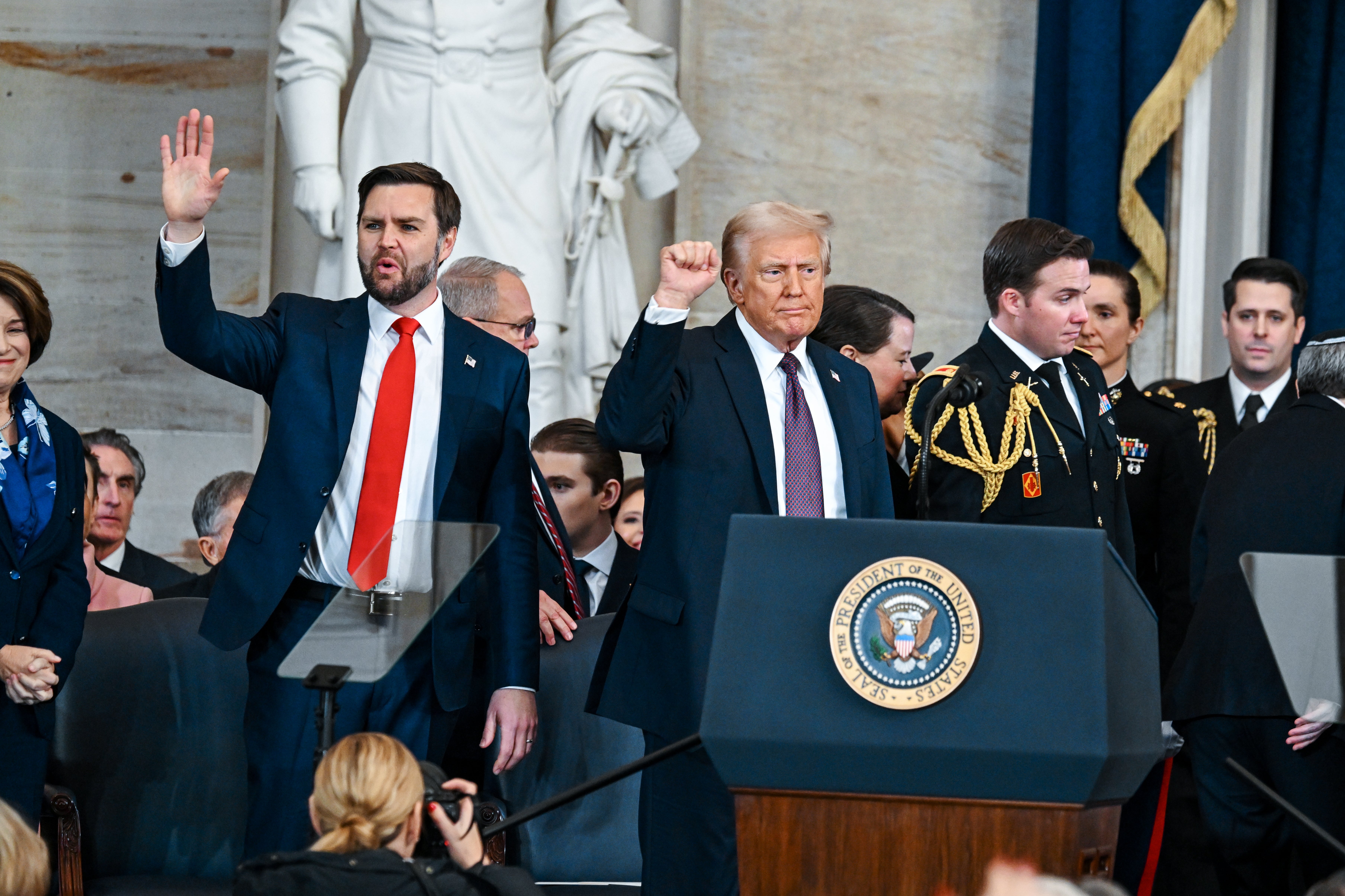 President Donald Trump and Vice President JD Vance gesture to a crowd. Vance defended Trump on X, claiming the president ‘chooses his words carefully’