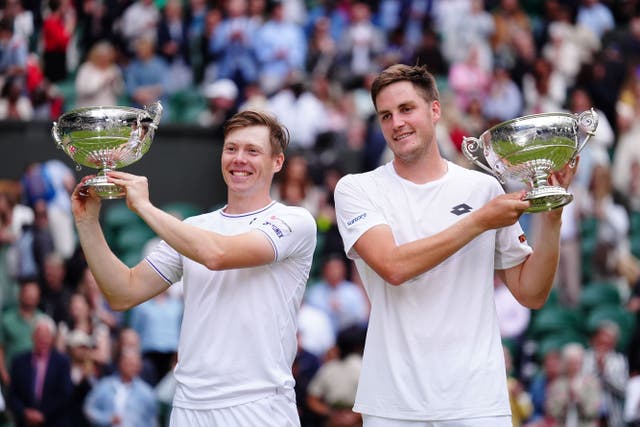 Henry Patten, right, and Harri Heliovaara with their Wimbledon trophies (Mike Egerton/PA)