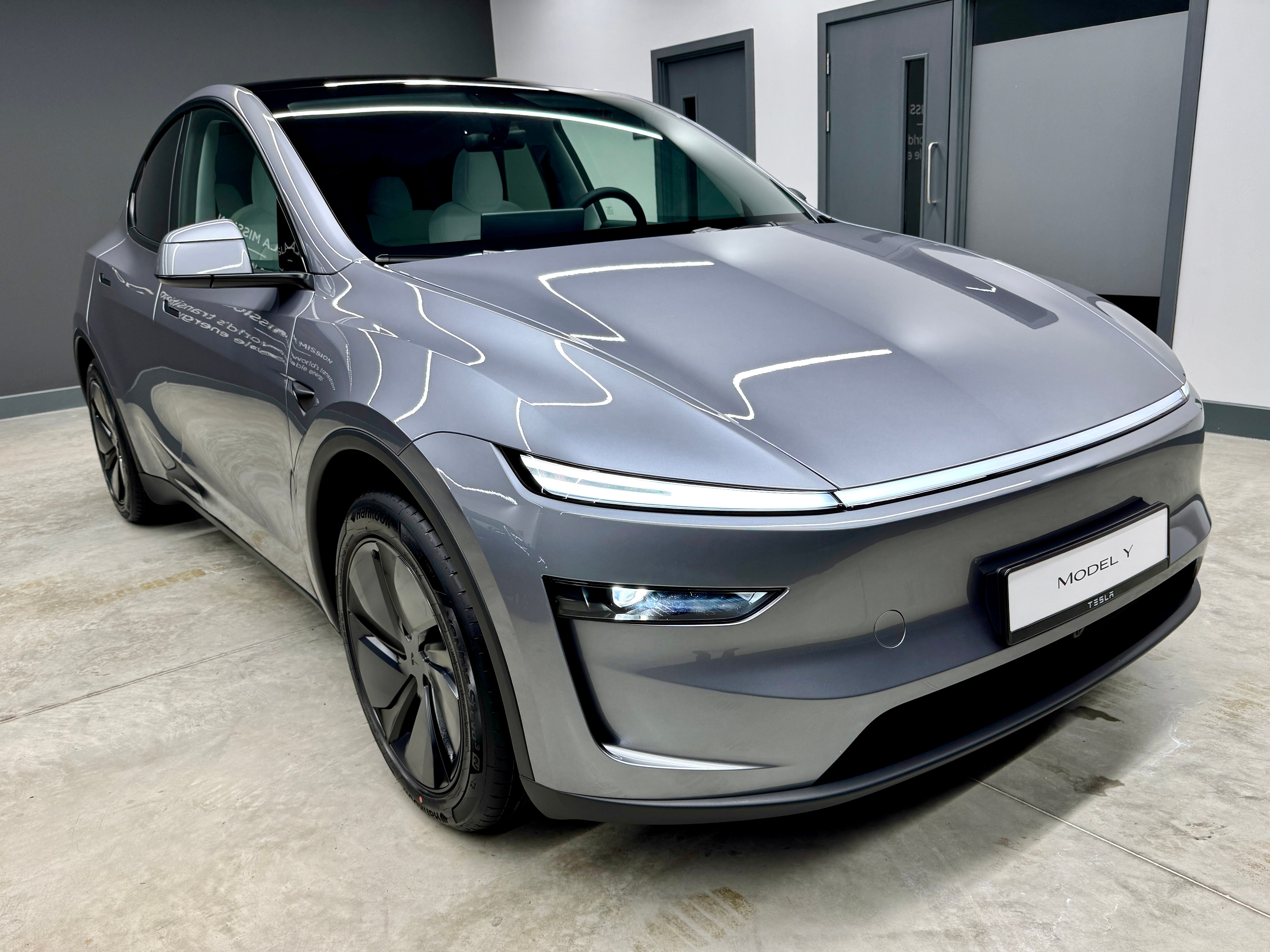 The new Tesla Model Y looks striking in real life with its full-width LED light bar at the front