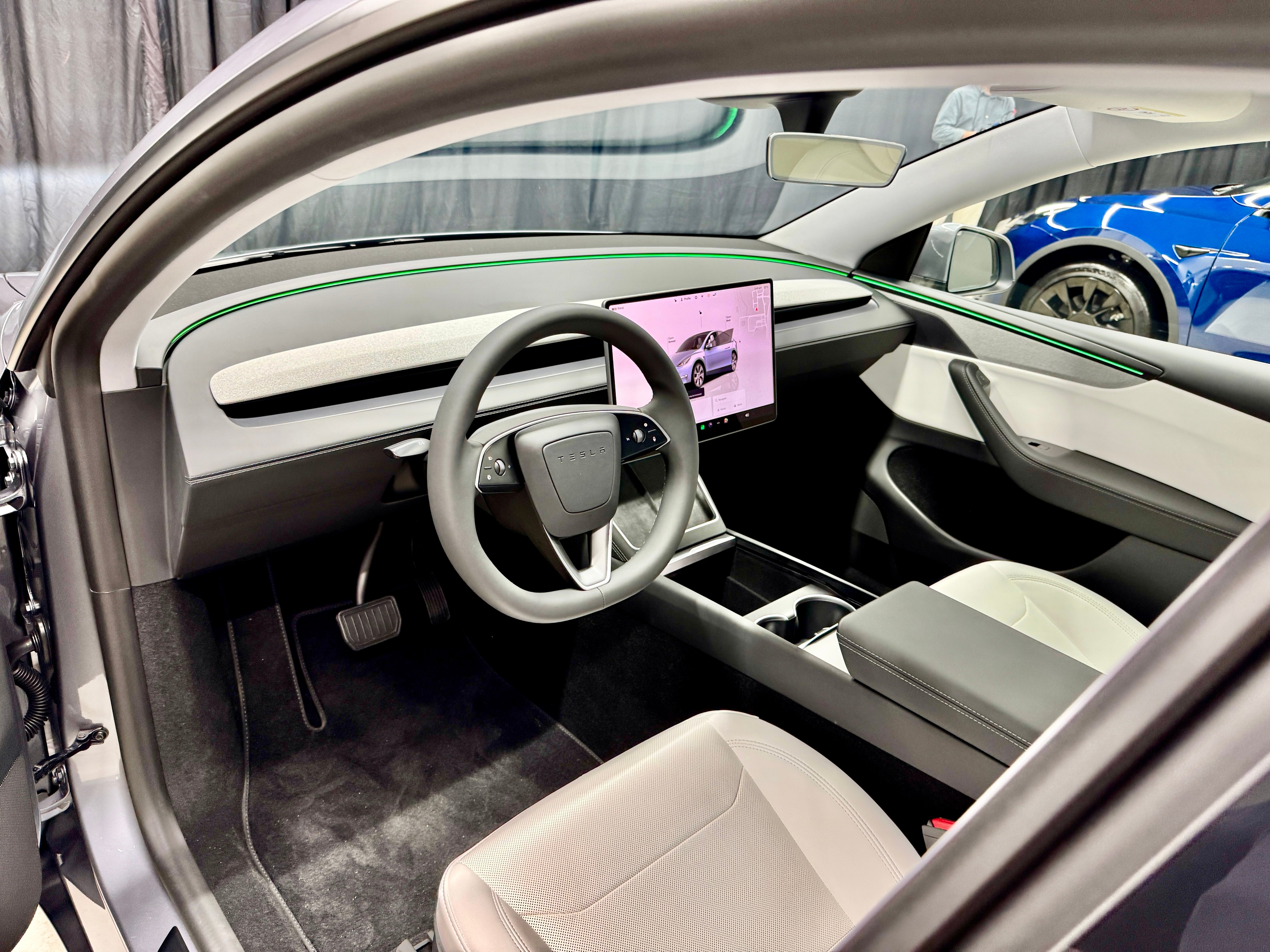 New ambient lighting, cloth inserts on the dash, a new steering wheel and ventilated seats feature in a quieter cabin in the new Tesla Model Y