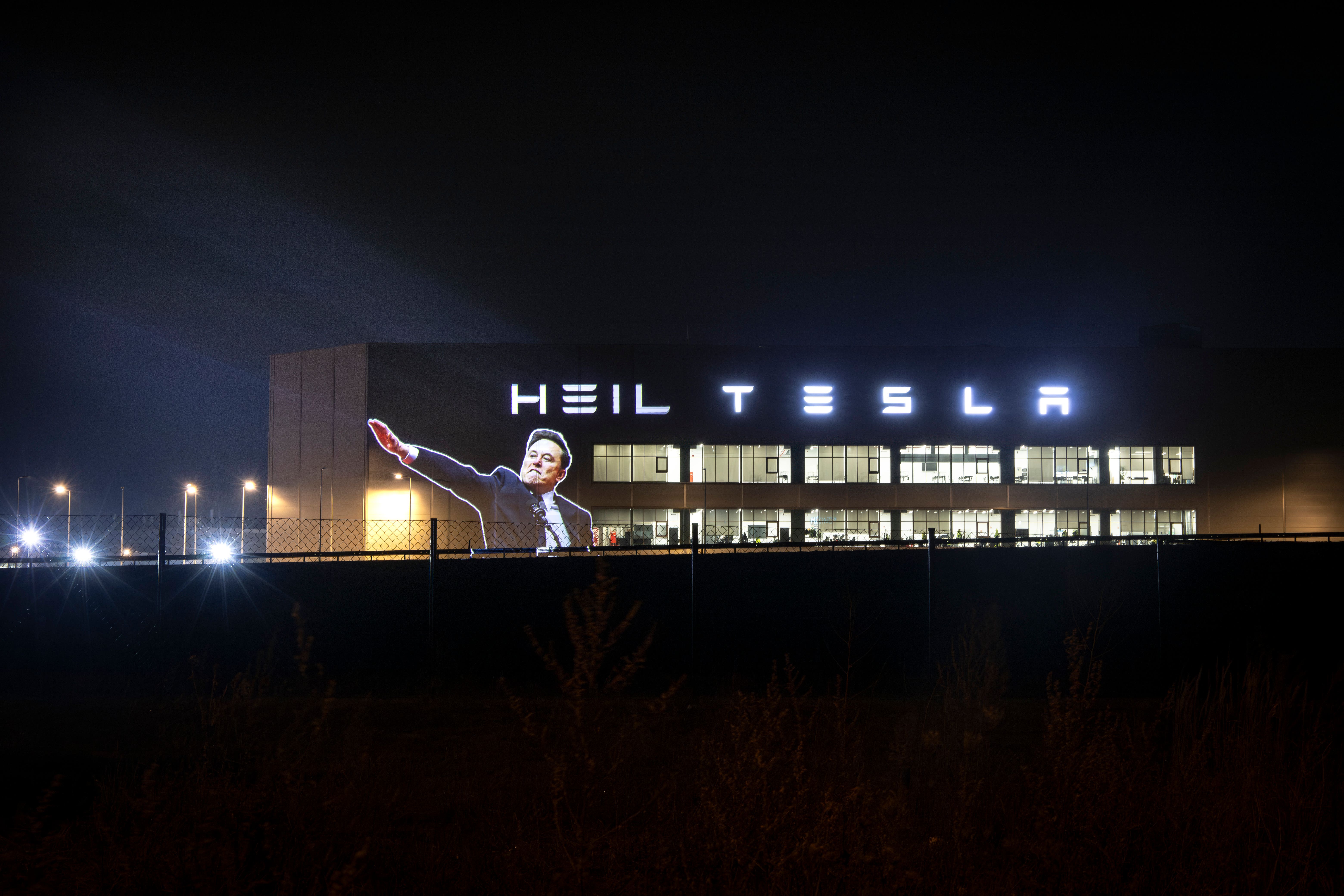 An image of Elon Musk making a controversial hand gesture widely interpreted as a Nazi salute has been projected onto the side of a Tesla building in Berlin (Led By Donkeys)