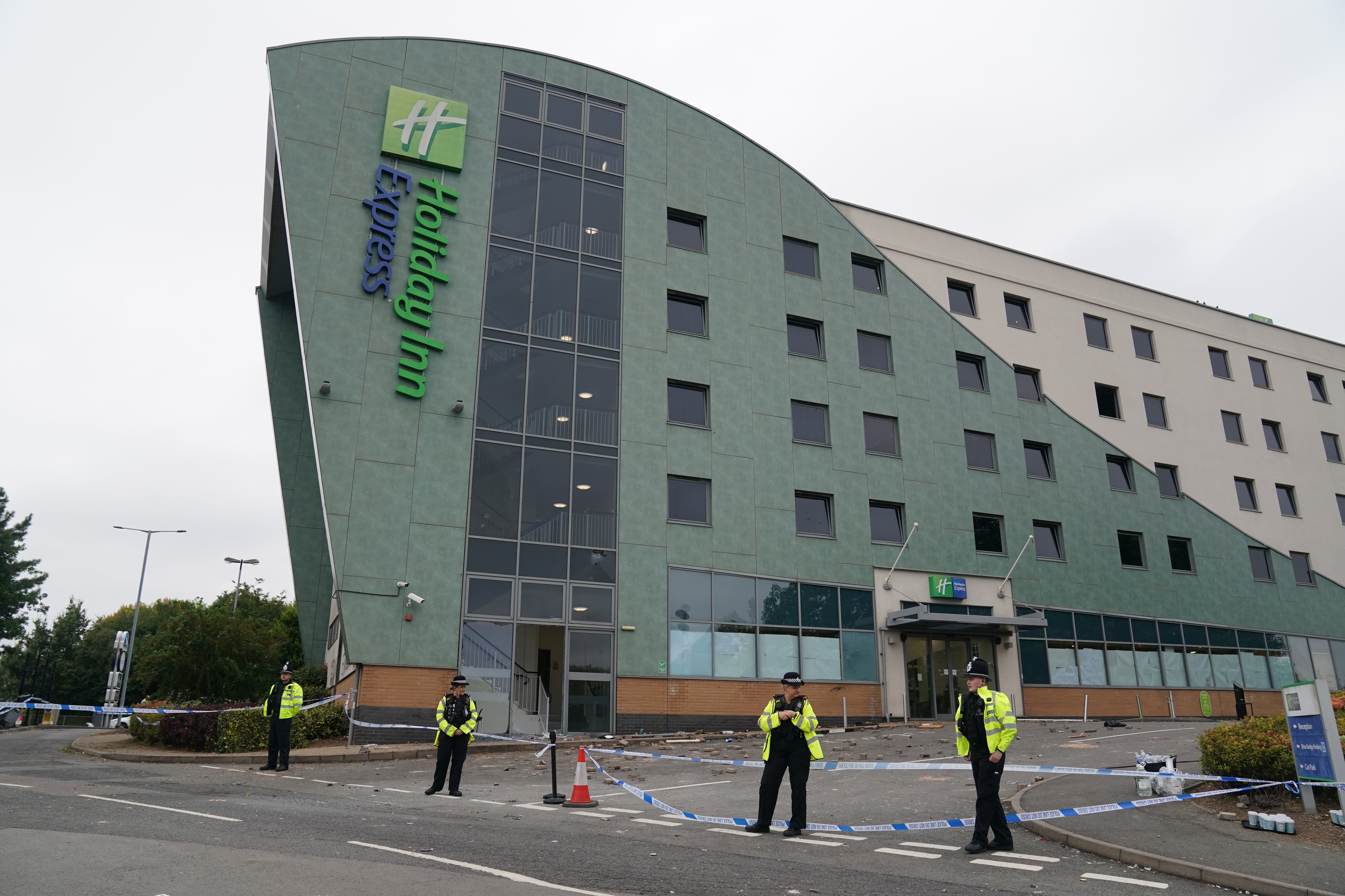 Police officers guarding Holiday in Express in Tamworth, a day after trouble