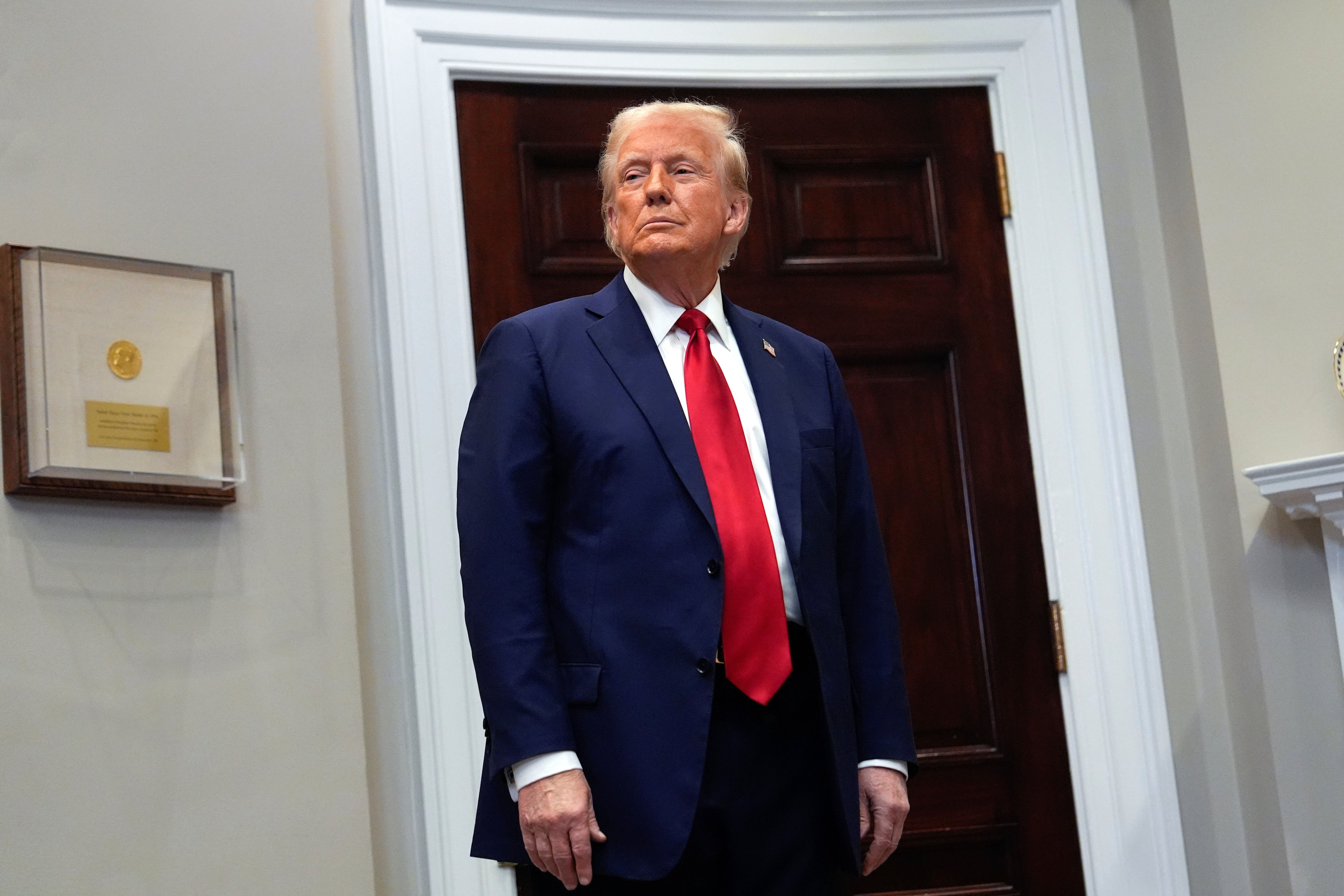 President Donald Trump stands at the White House. Trump has blasted California Democrats over their response to recent deadly wildfires in and around Los Angeles, as well as their water policy and systems