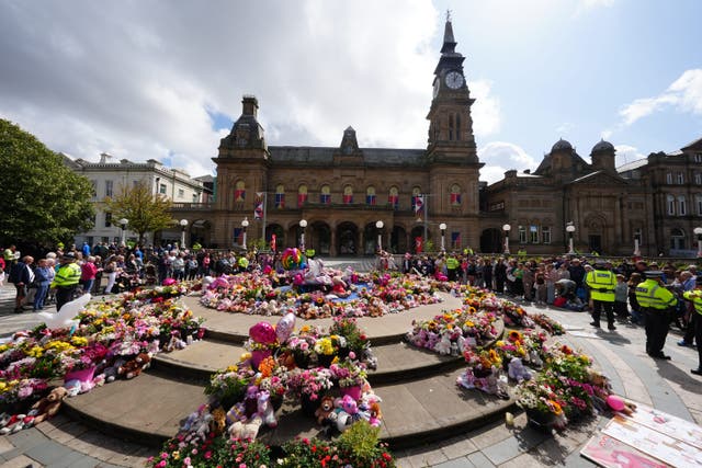 Flowers and tributes outside the Atkinson Art Centre, Southport (Owen Humphreys / PA)