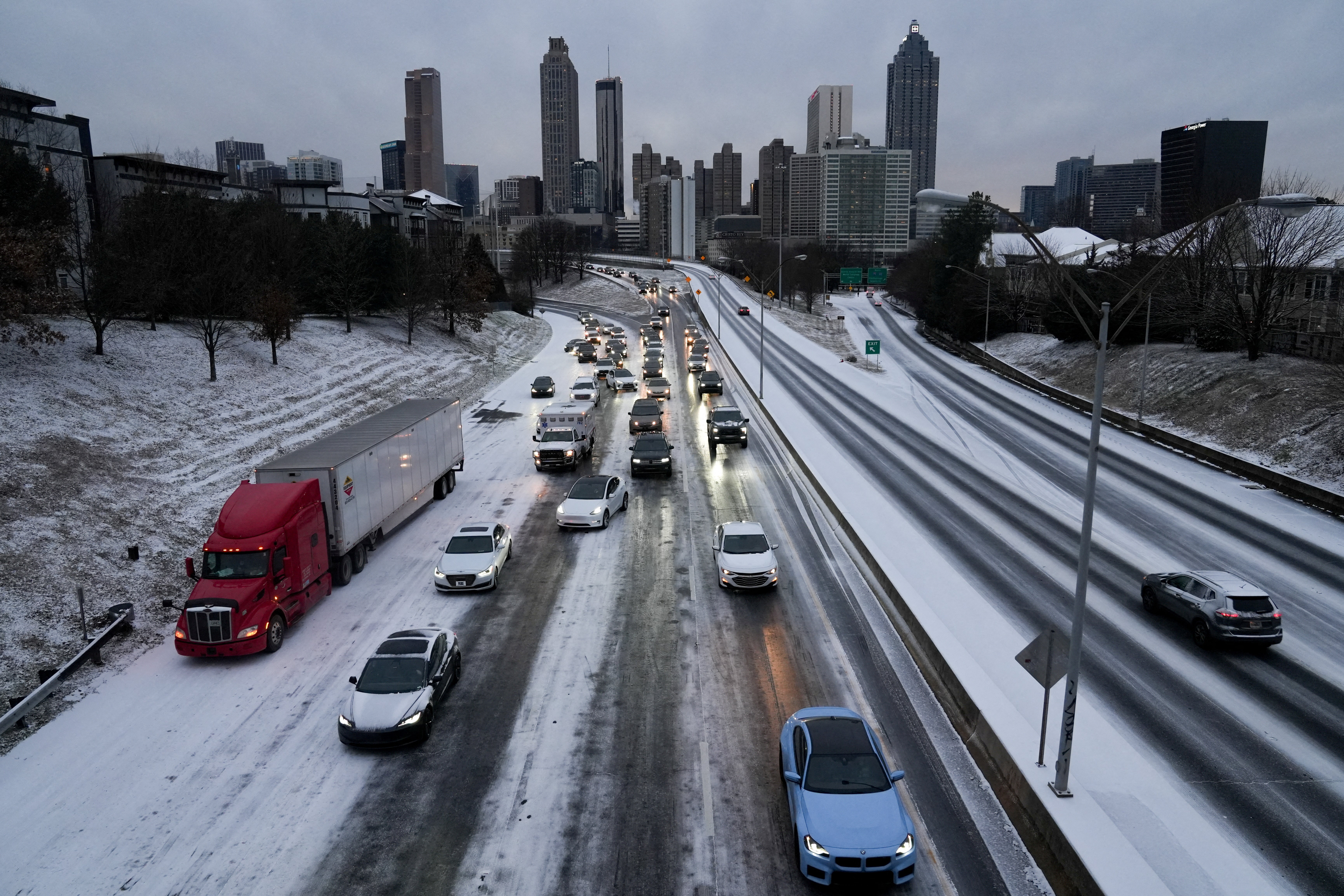 Drivers in Georgia slept in their cars after light snow and icy roads forced traffic to a miles-long standstill