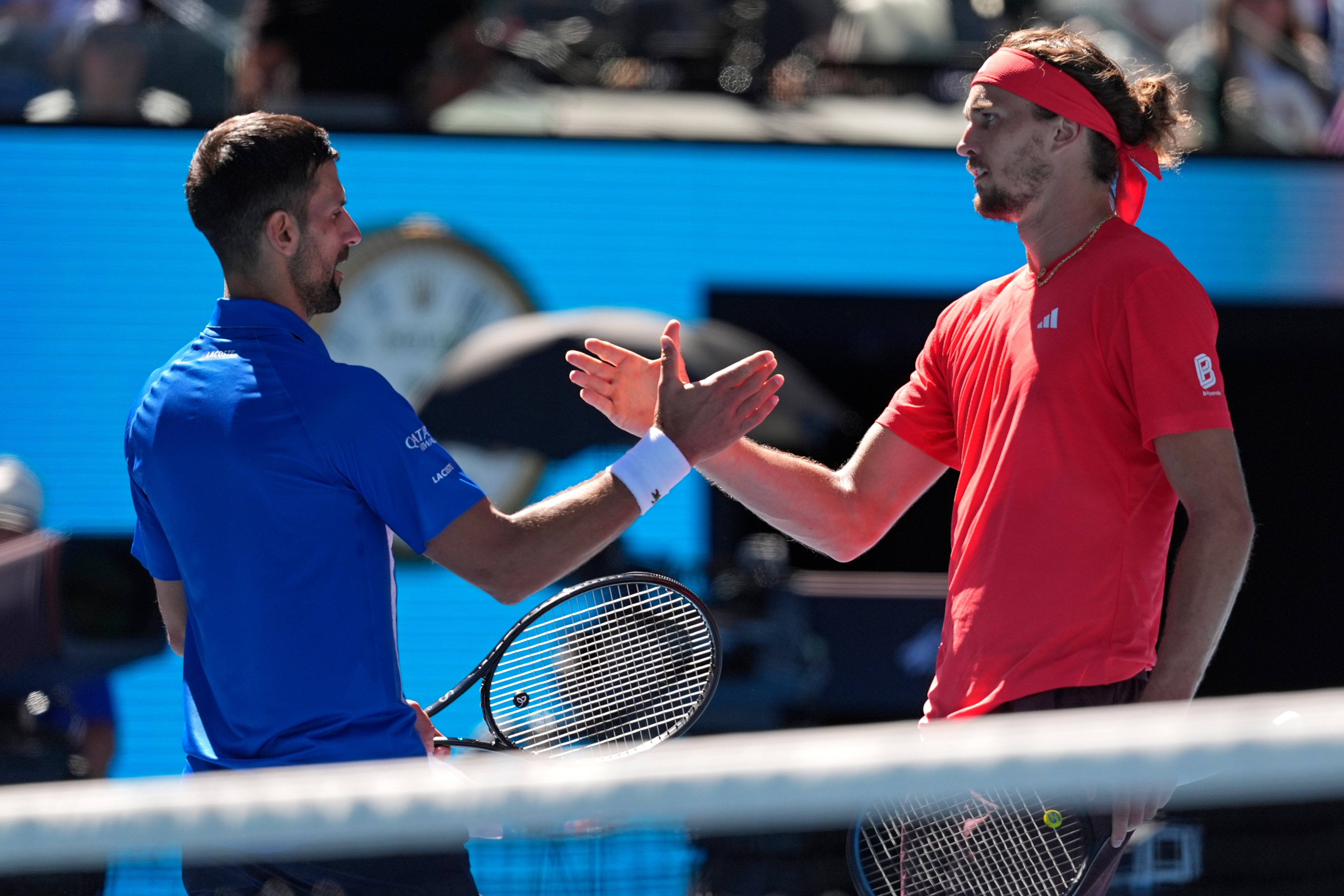 Alexander Zverev shakes hands with Novak Djokovic after the first set tiebreak