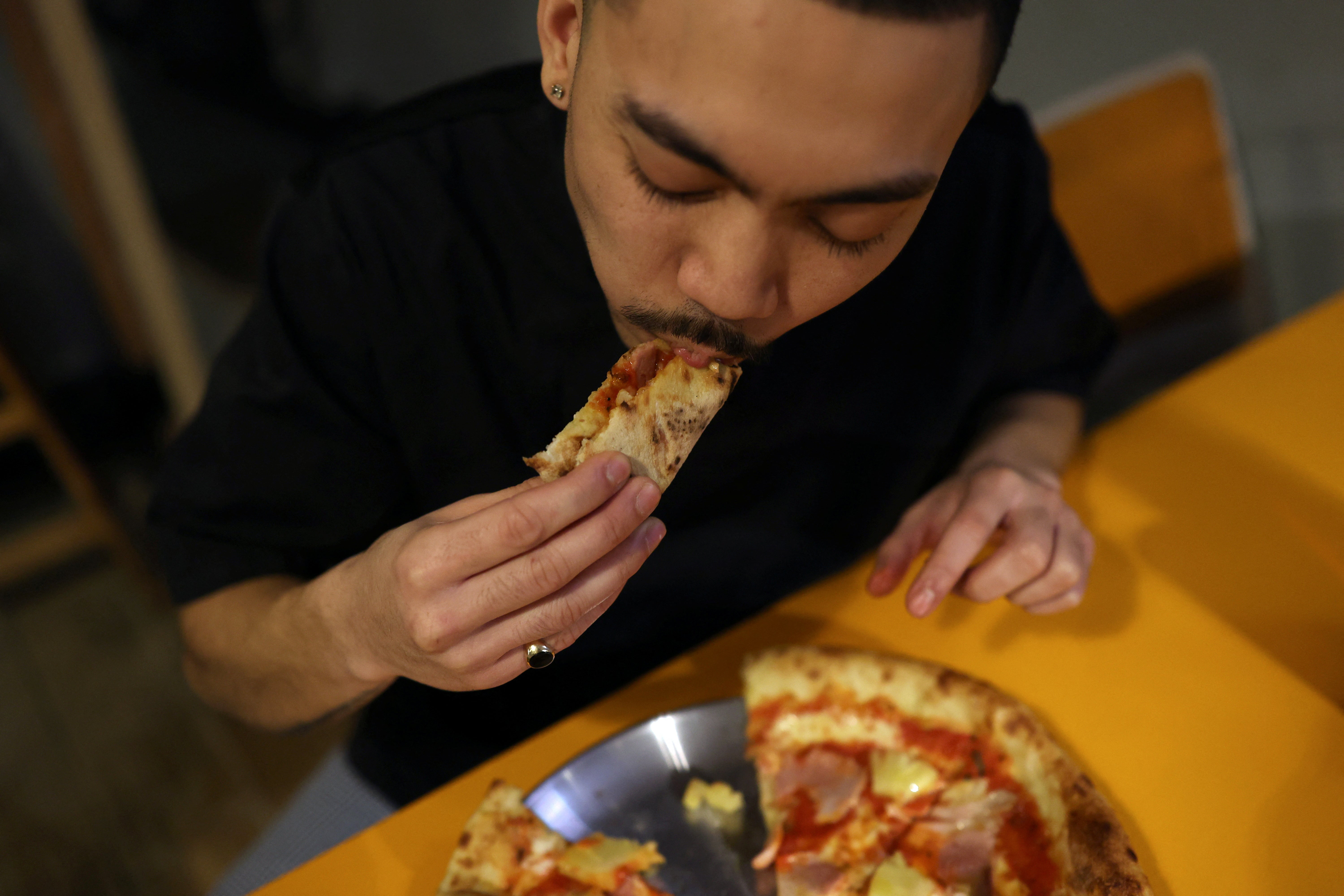 Chef Kevin Giannoran tastes Hawaiian, ham and pineapple pizza at Pizza Lupa in Norwich.