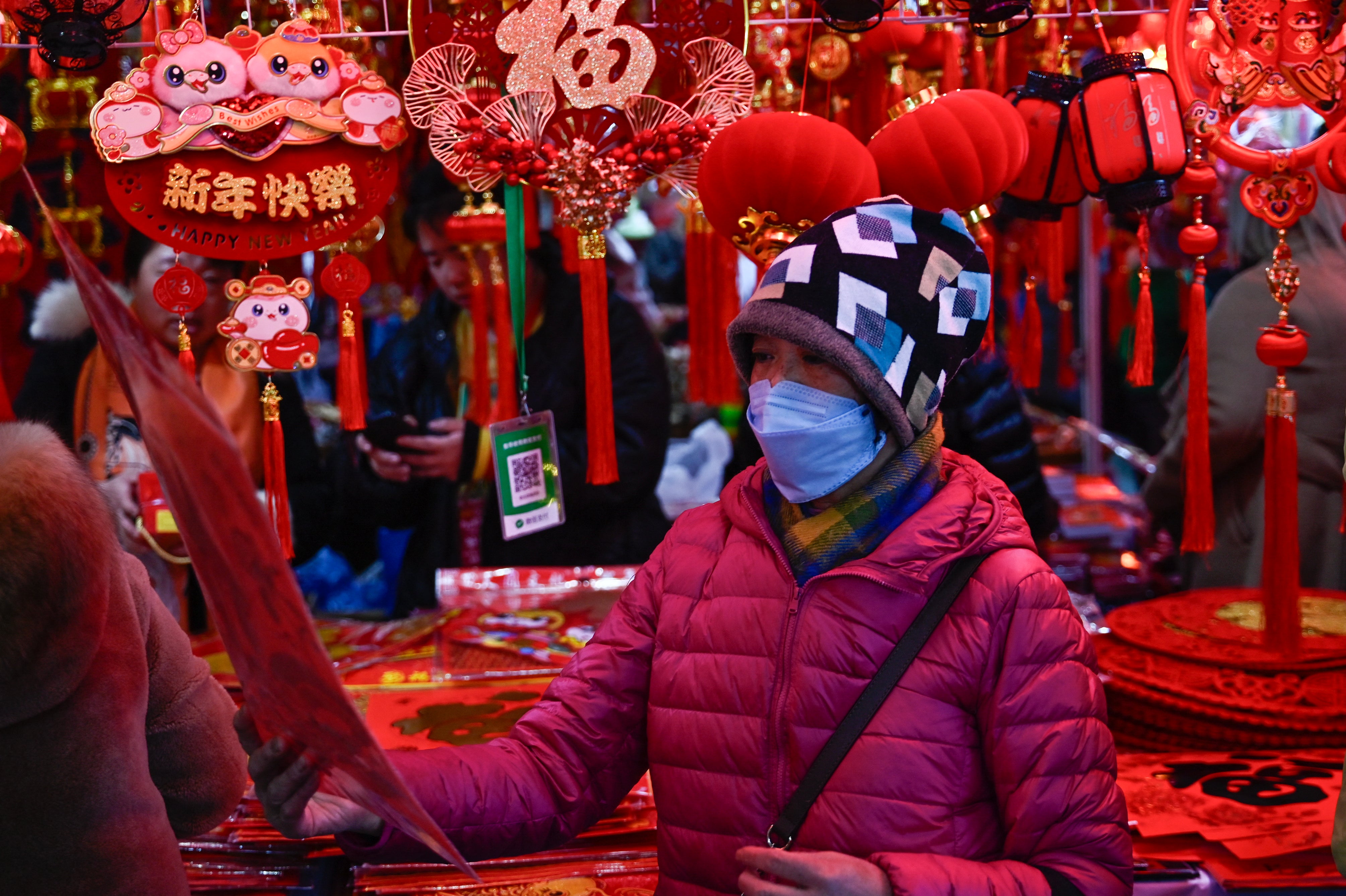 A woman looks at a decoration at a market in Beijing on January 24, 2025
