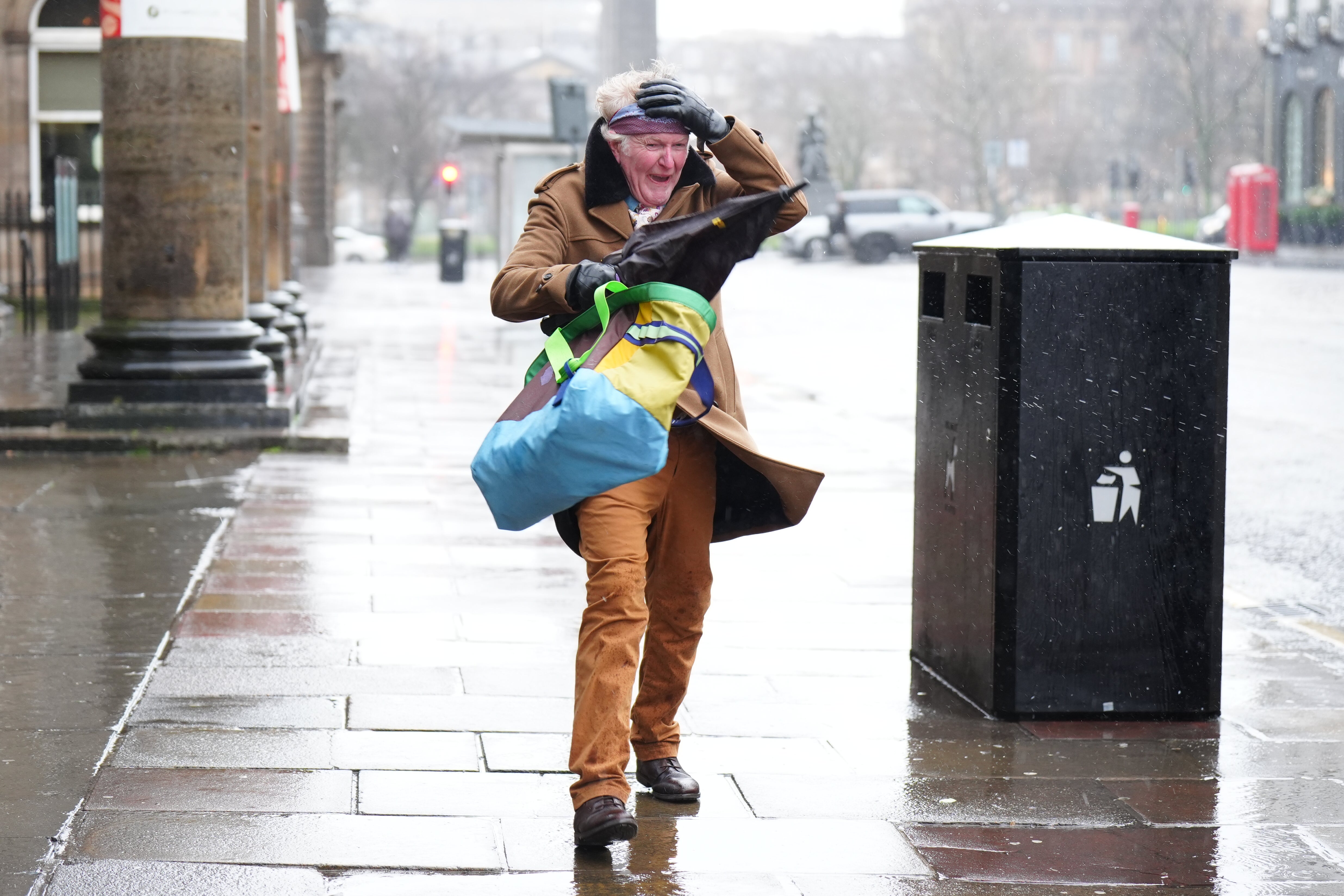 A member of the public braves the wind in Edinburgh