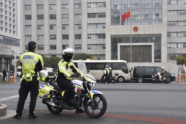 <p>Police officers patrol near the Jiangsu Suzhou Intermediate People’s Court in Suzhou, west of Shanghai, China</p>