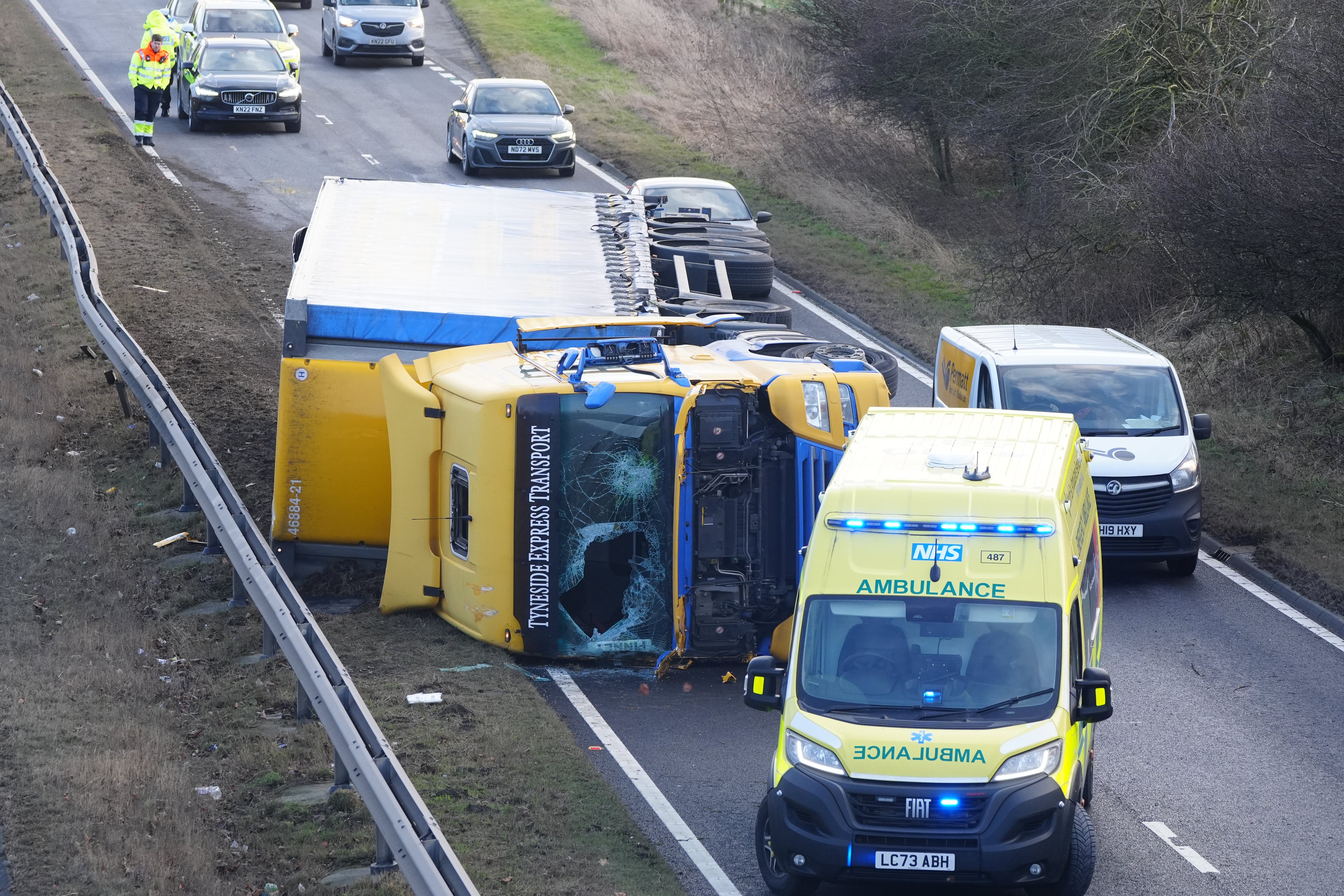 An ambulance attends the scene of a crash after strong winds on the north bound A19 in Durham