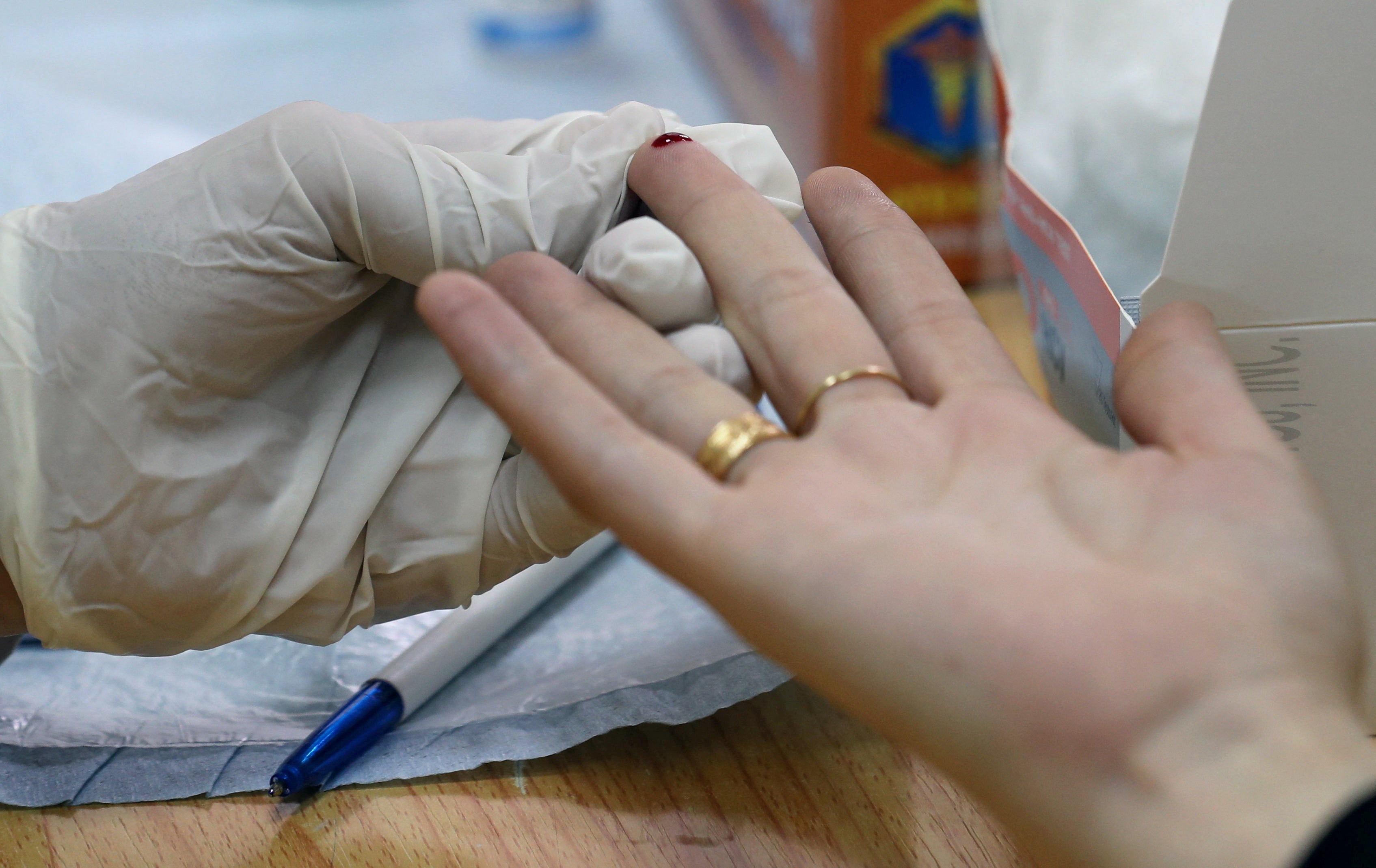 An Egyptian doctor makes a test during an unprecedented campaign that aims to test 50 million people to detect and treat hepatitis C patients in a bid to eliminate the disease by 2022, in Cairo, Egypt