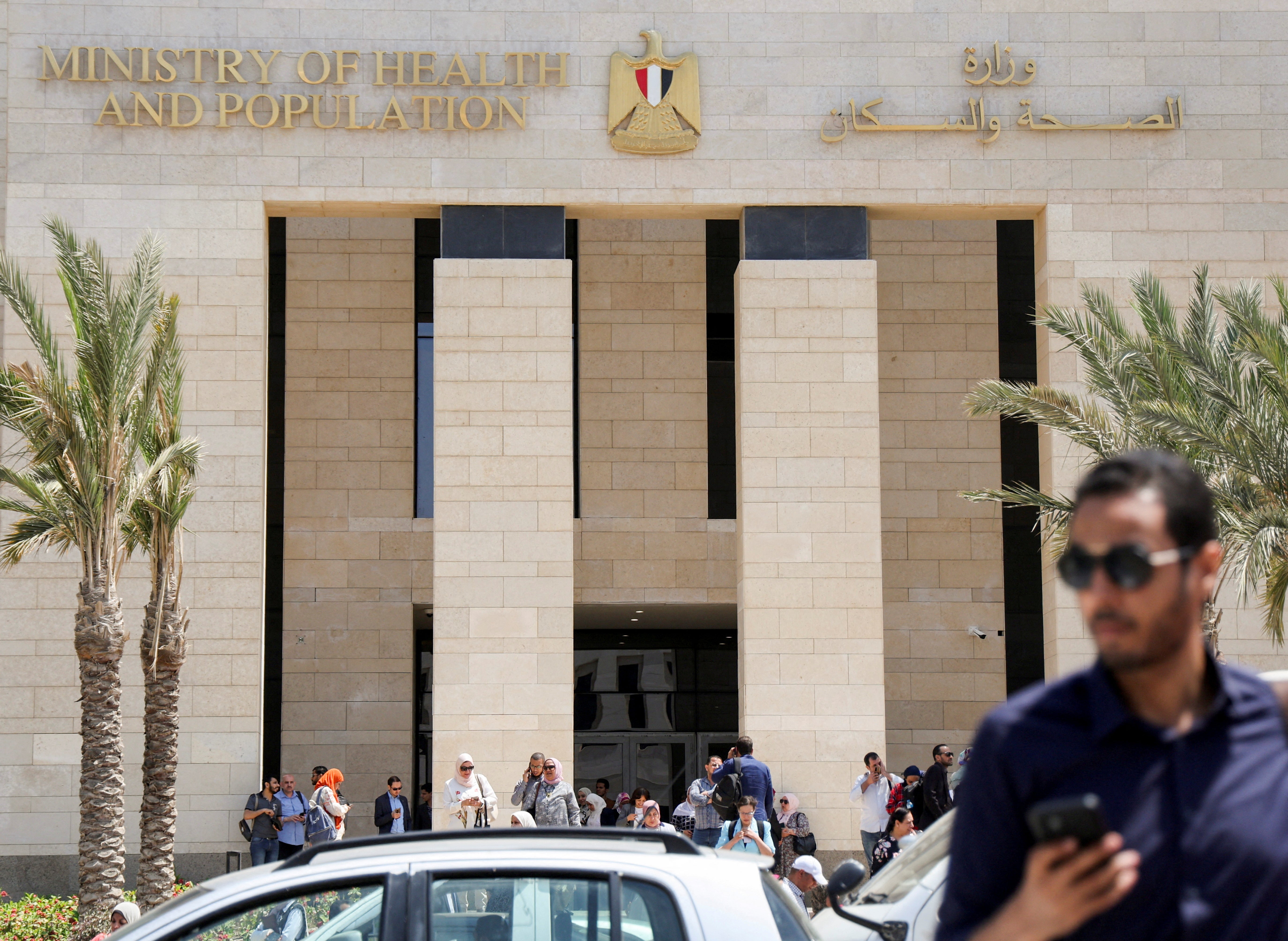Employees walk after work, outside the new building of Egypt’s Ministry of Health and Population (MoHP) in the New Administrative Capital (NAC), east of Cairo, Egypt