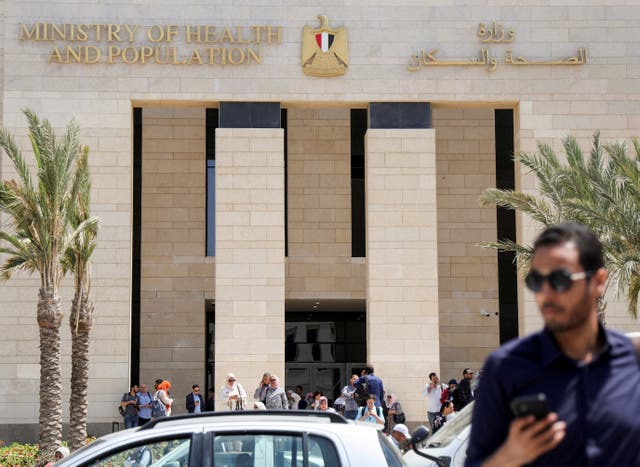 <p>Employees walk after work, outside the new building of Egypt’s Ministry of Health and Population (MoHP) in the New Administrative Capital (NAC), east of Cairo, Egypt</p>