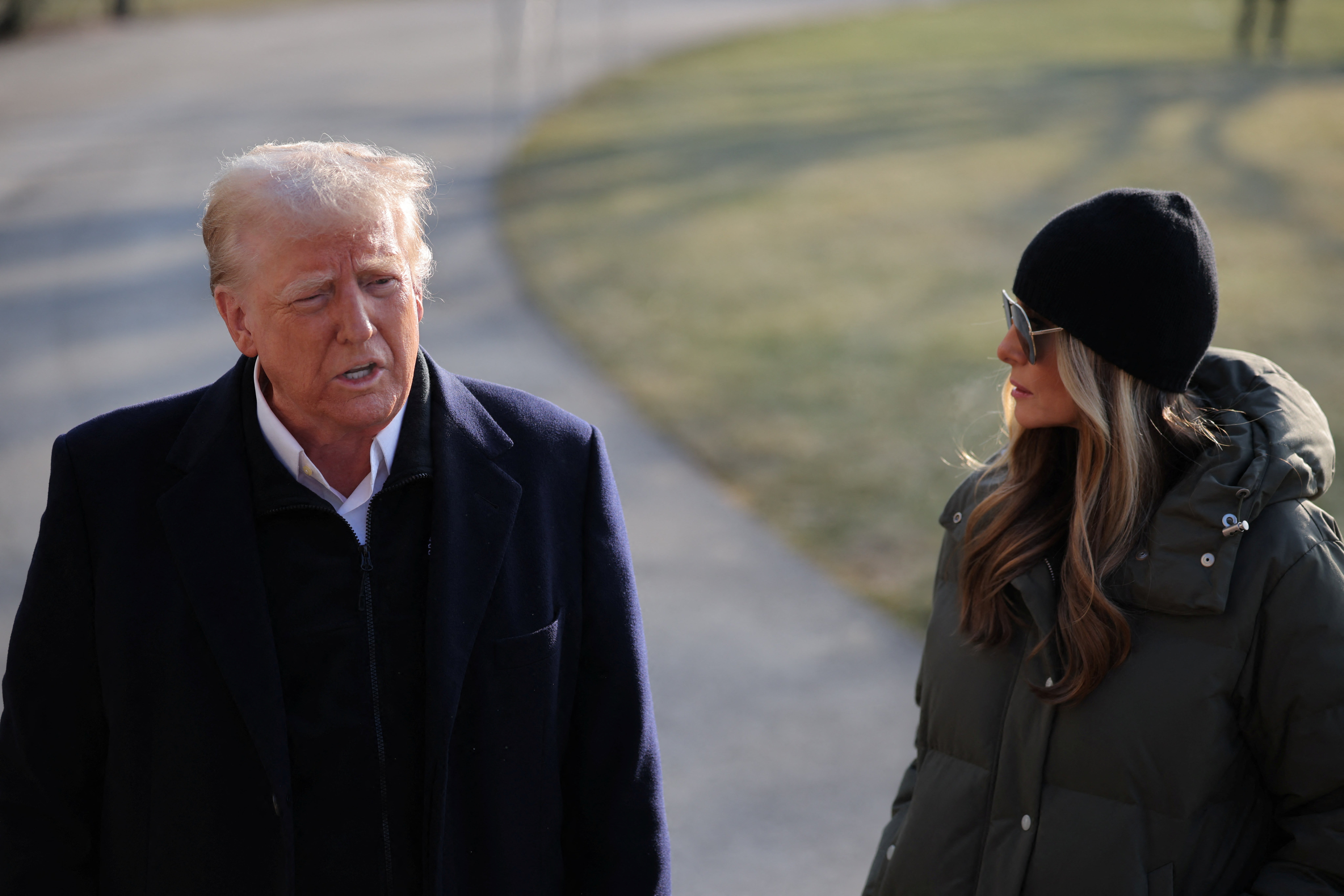 President Donald Trump speaks to the media, next to first lady Melania Trump, during departure from the White House on a visit to Asheville, NC, and Los Angeles, CA.