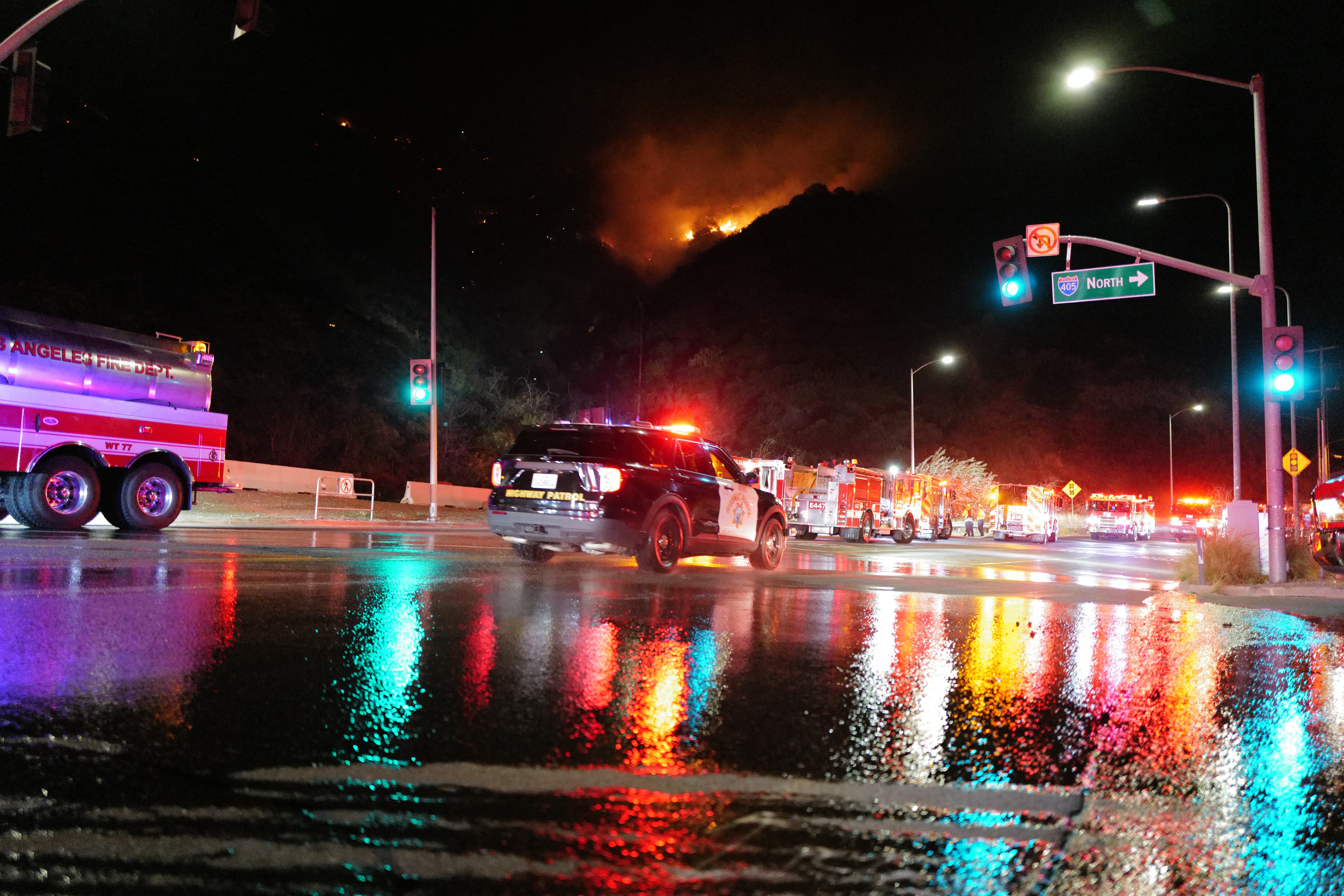 Firefighters work while the Sepulveda fire is burning in Los Angeles, California, on Thursday. The blaze is 60 percent contained