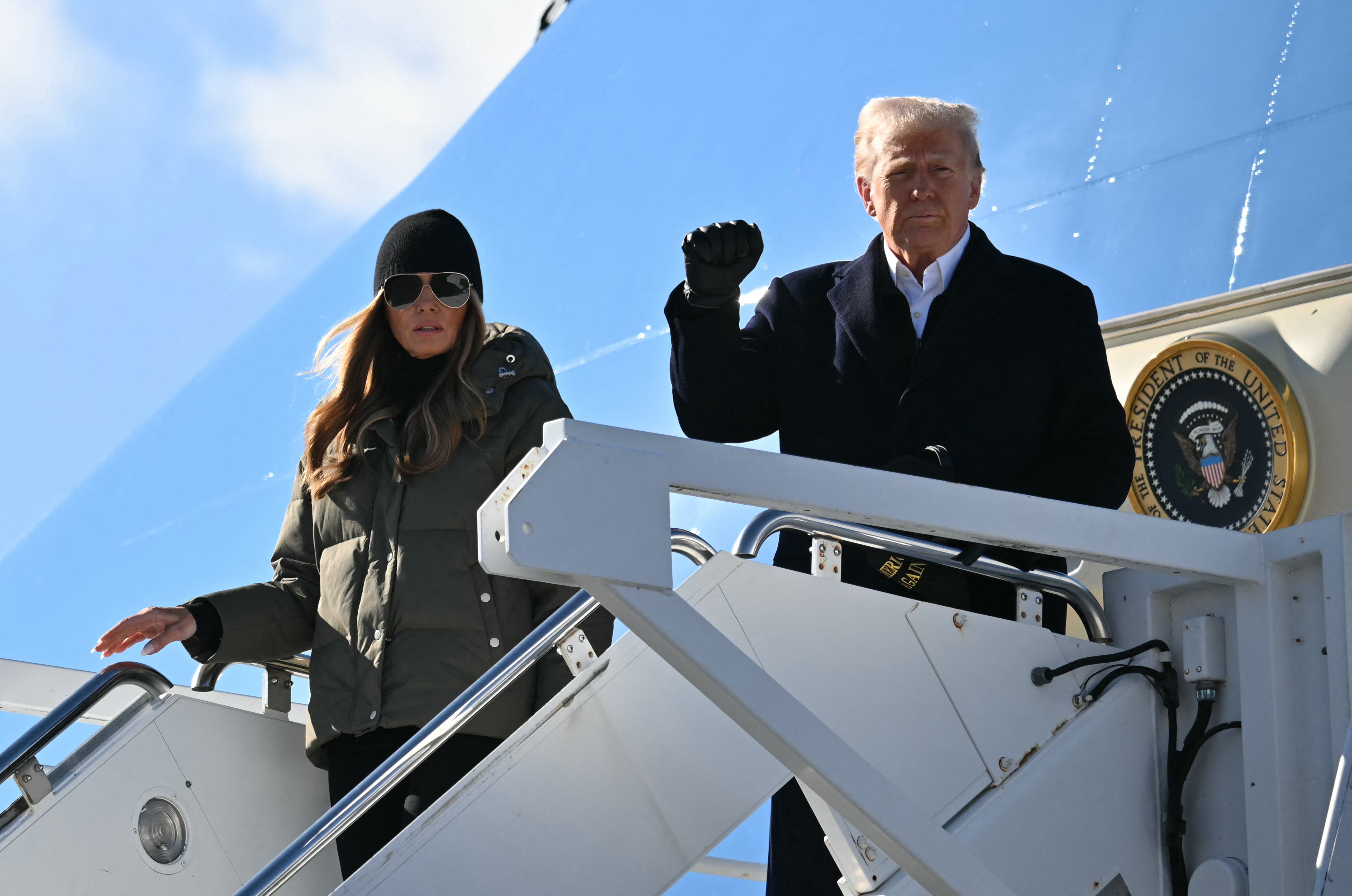 President Donald Trump, with First Lady Melania Trump, steps off of Air Force One upon arrival at Asheville Regional Airport